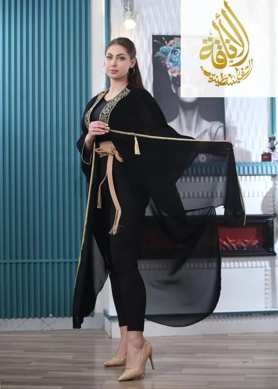 Palestinian Elegance embroidered chiffon cardigan in black with gold trim worn by a model