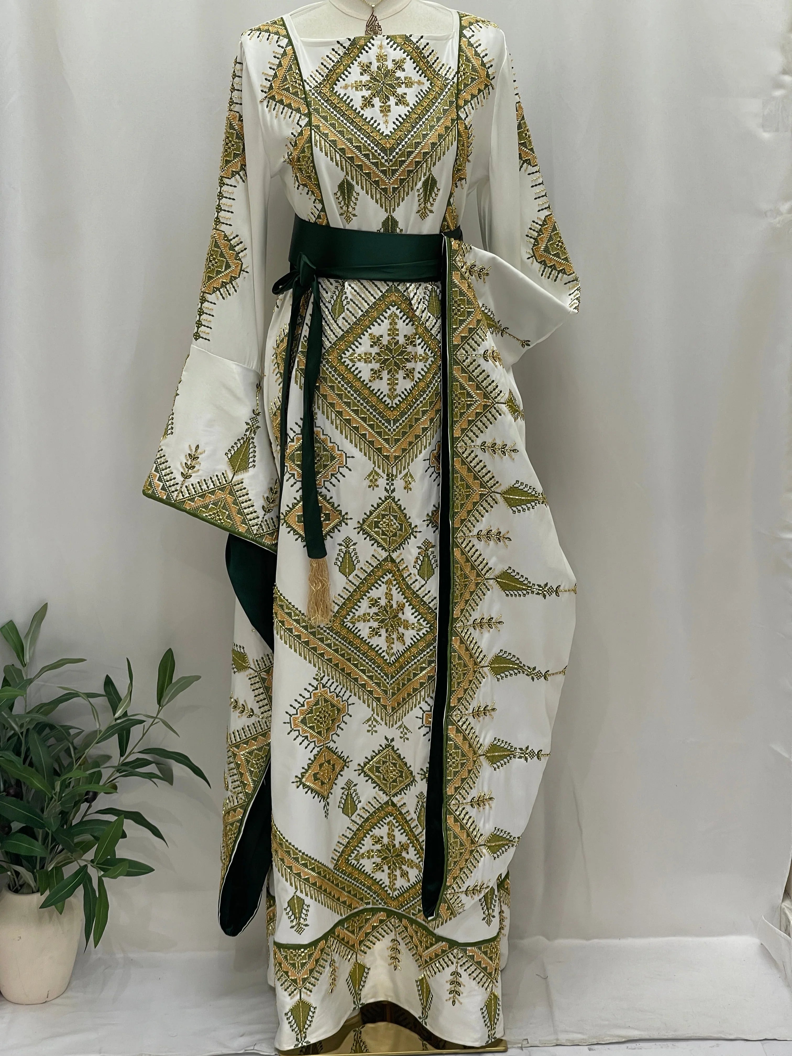 Olive Bloom Bridal Embroidered Dress white gown with green and gold Palestinian embroidery long bell sleeves and green sash