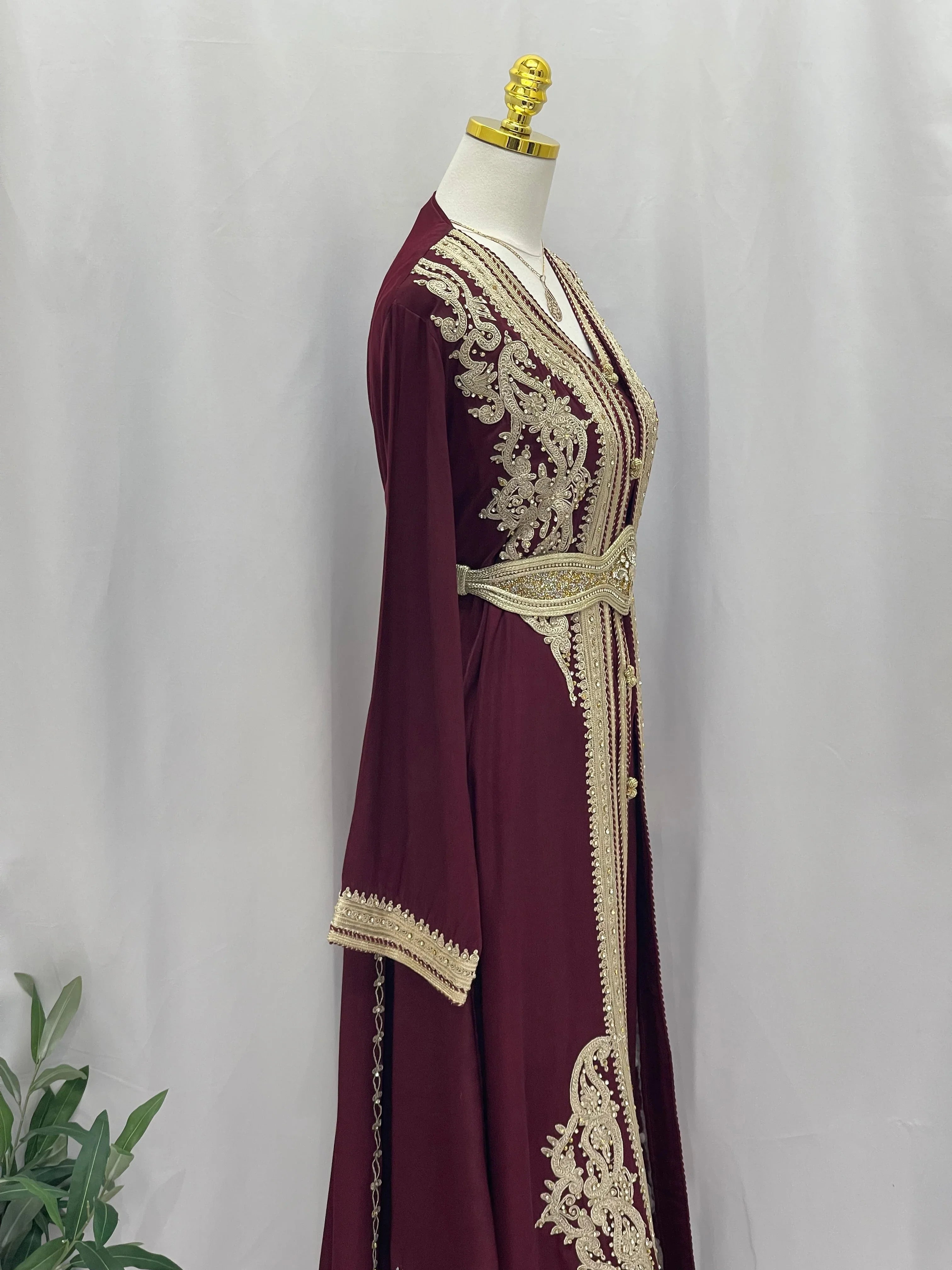 Omima Morocco Style Kaftan by Palestinian Elegance in maroon with intricate gold embroidery and matching belt