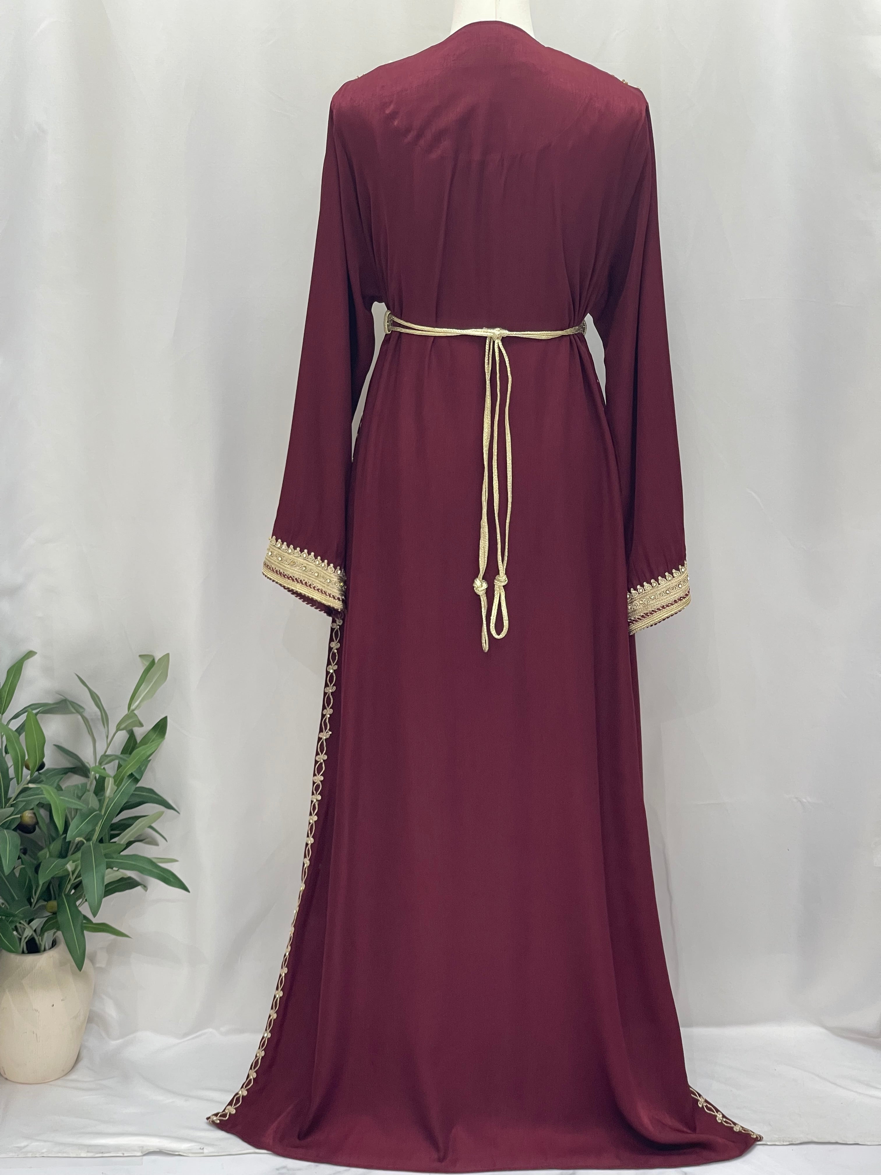 Back view of Omima Morocco Style Kaftan by Palestinian Elegance in deep maroon with beige belt and sleeve trim