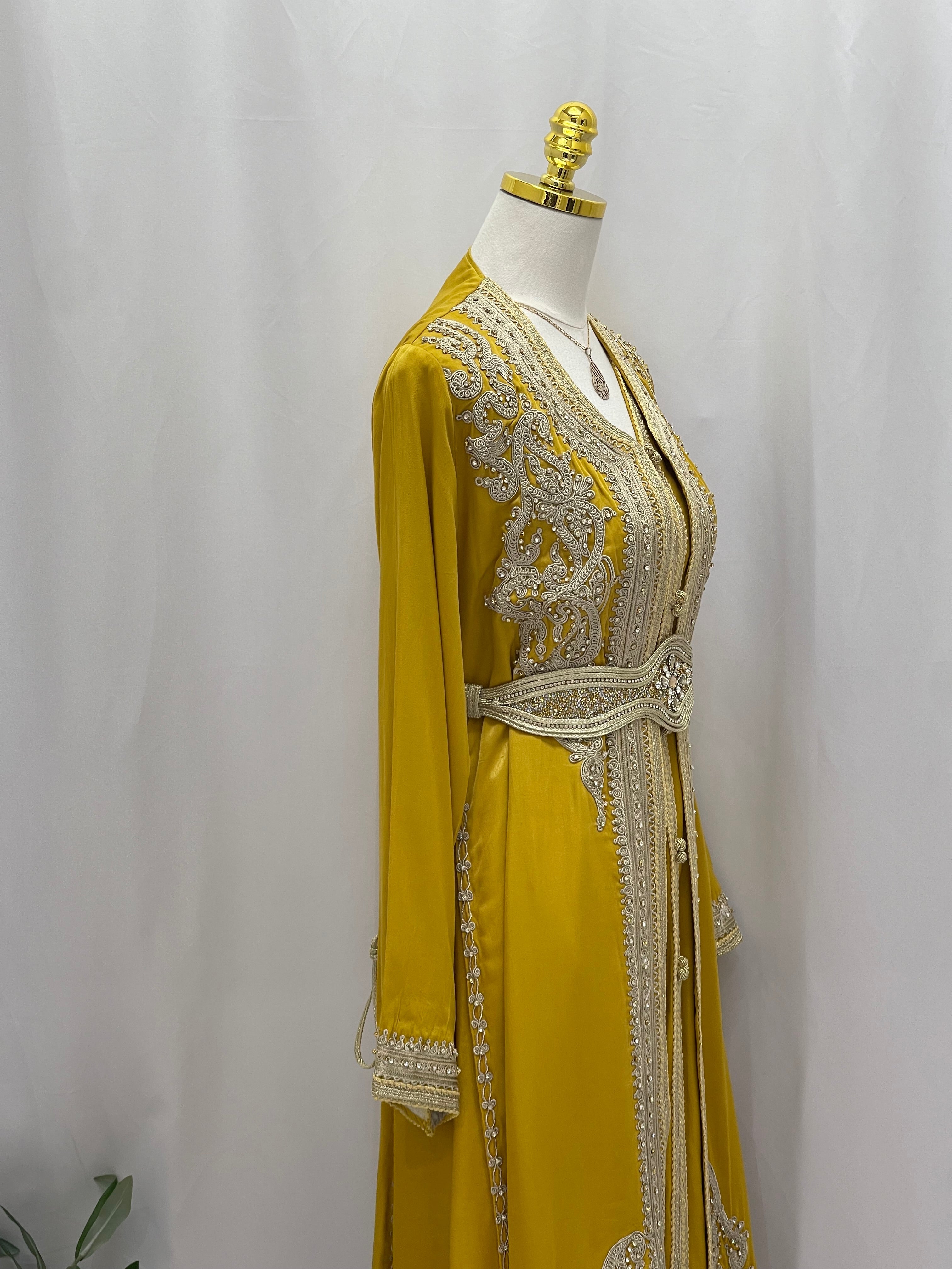 Golden yellow Omima Morocco Style Kaftan by Palestinian Elegance with intricate silver embroidery and matching belt