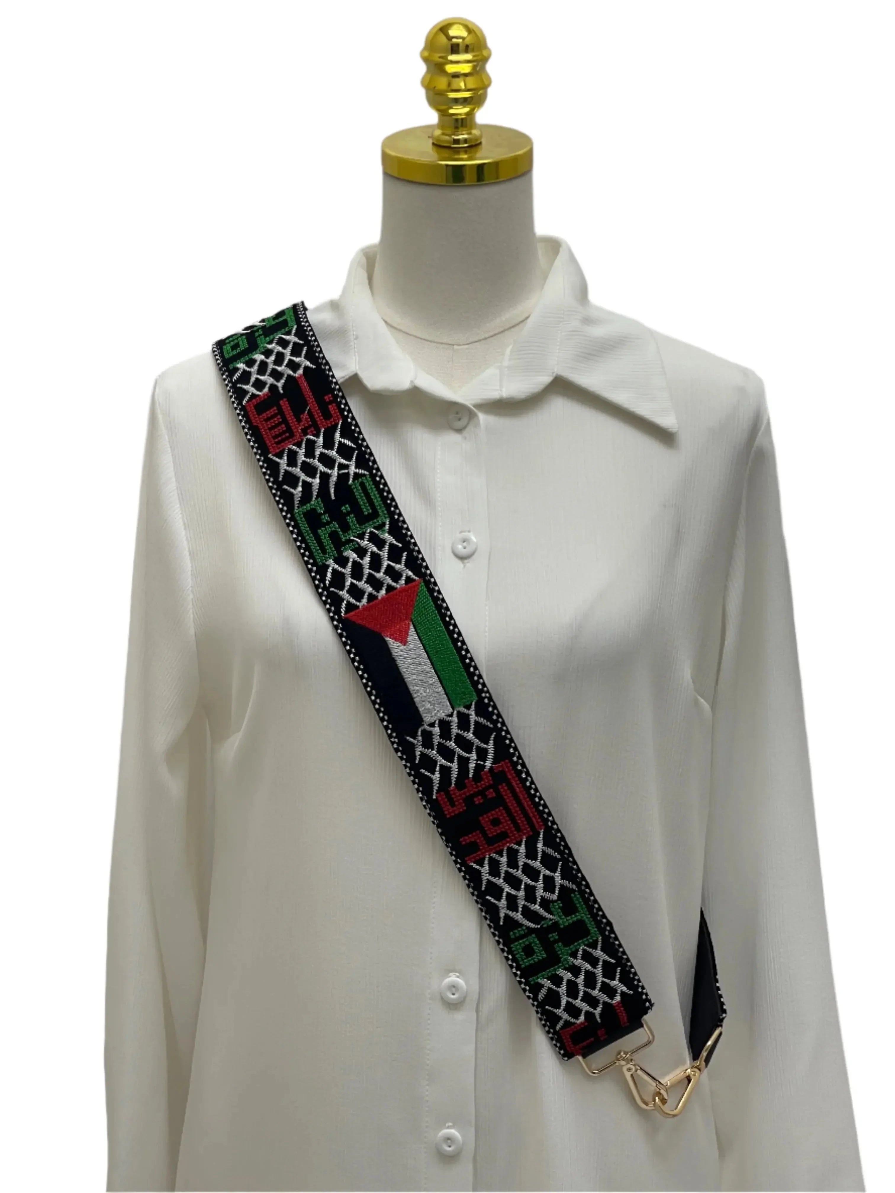 Palestine Embroidered Purse Strap with traditional red green and black patterns displayed on white shirt