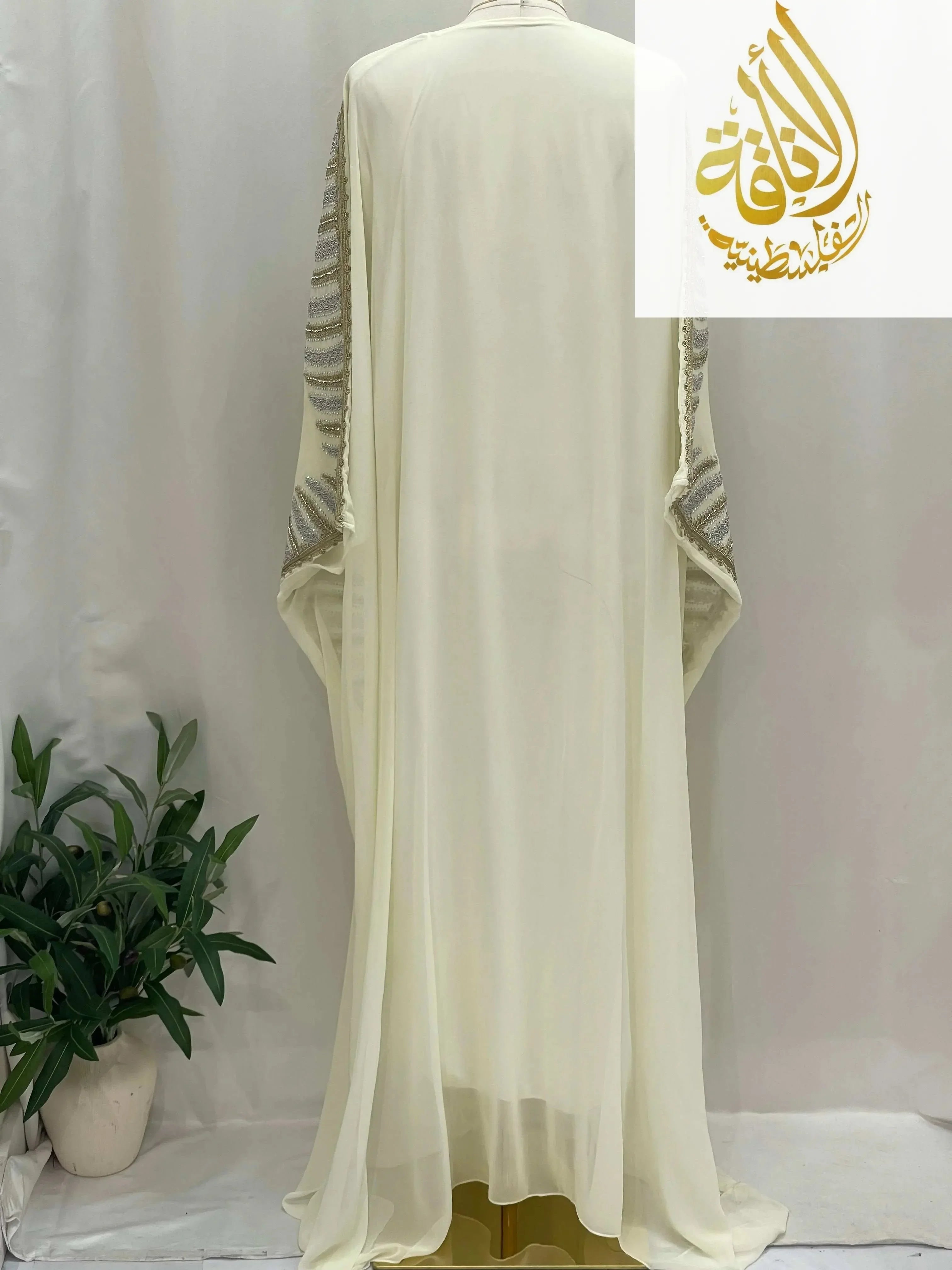 Back view of Dana Free Size Kaftan Abaya by Palestinian Elegance in cream with silver embellished sleeves