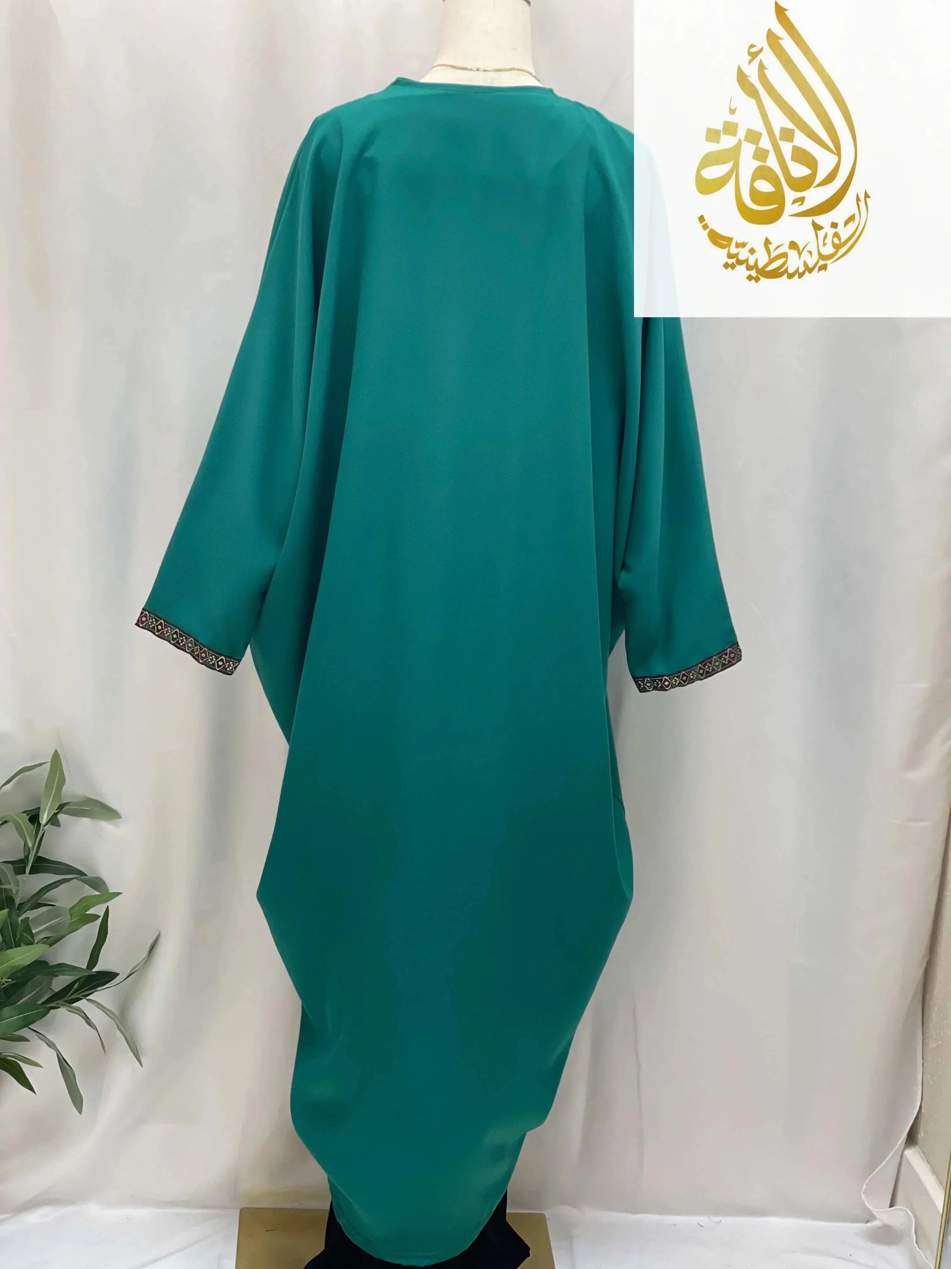 Palestinian Elegance Dana Free Size Kimono cardigan in teal with embroidered cuffs on mannequin