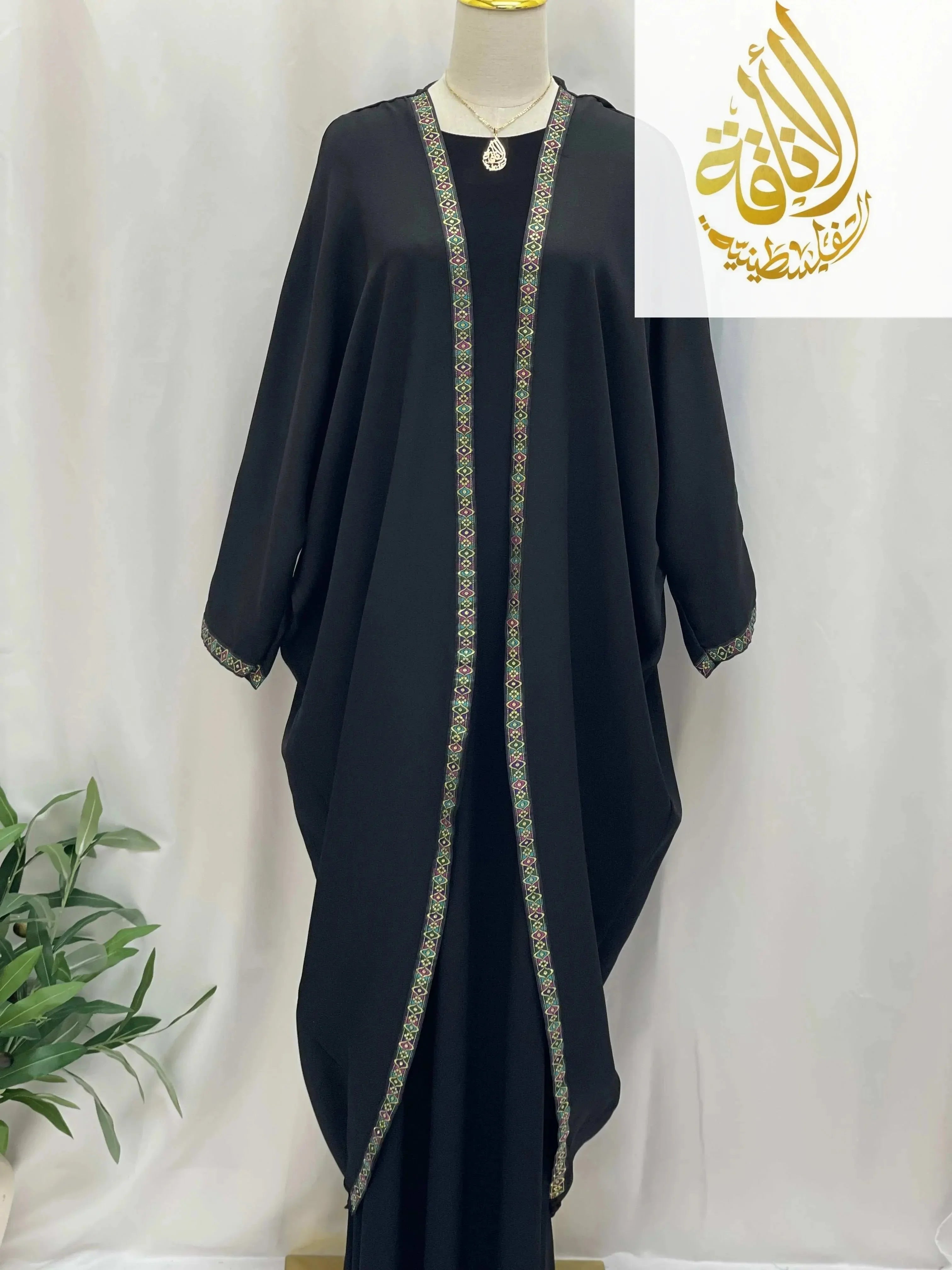 Palestinian Elegance Dana Free Size Kimono black cardigan with intricate patterned trim on a mannequin