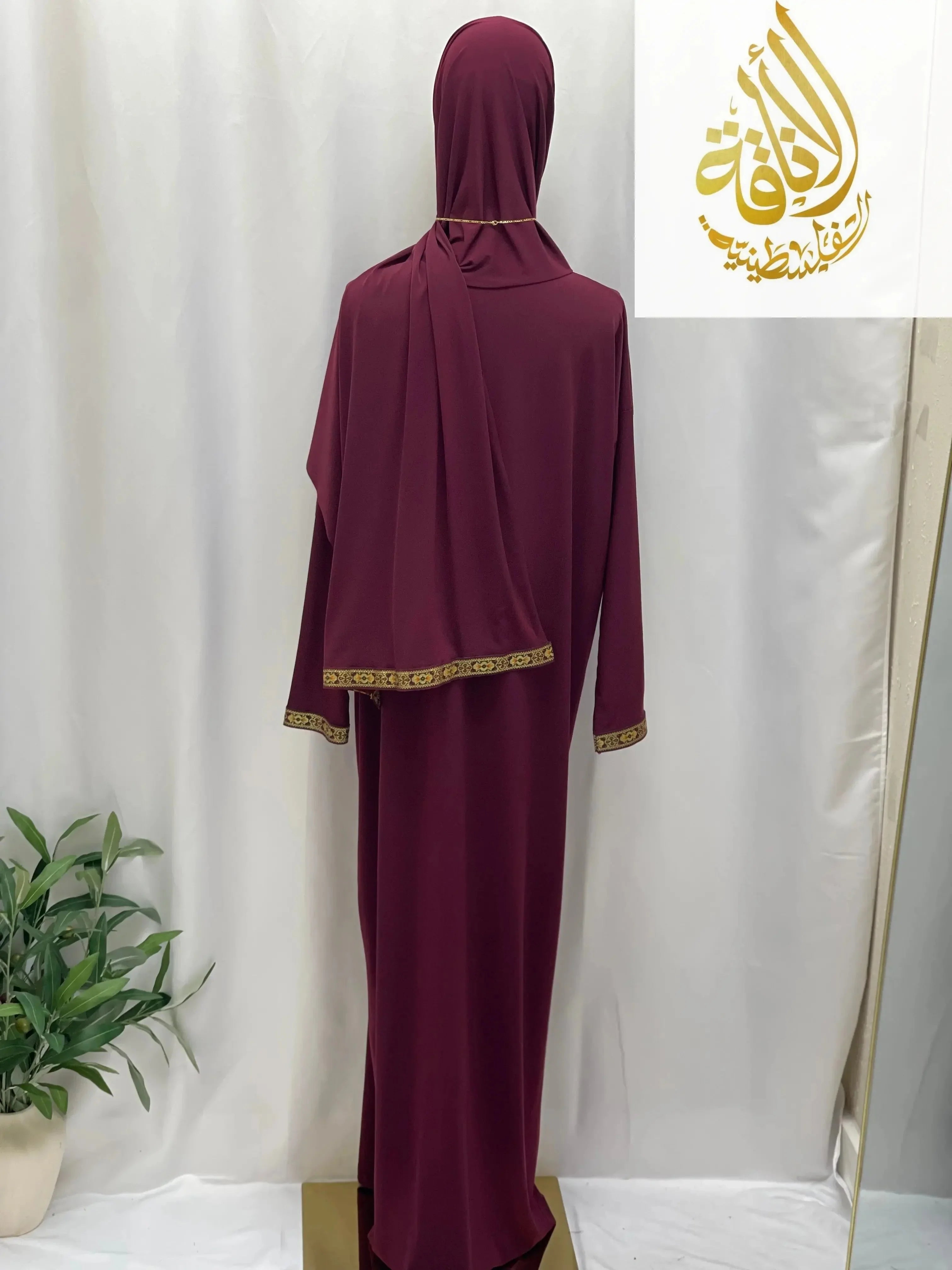 Palestinian Elegance burgundy one piece prayer dress with gold trim on cuffs and hijab edge