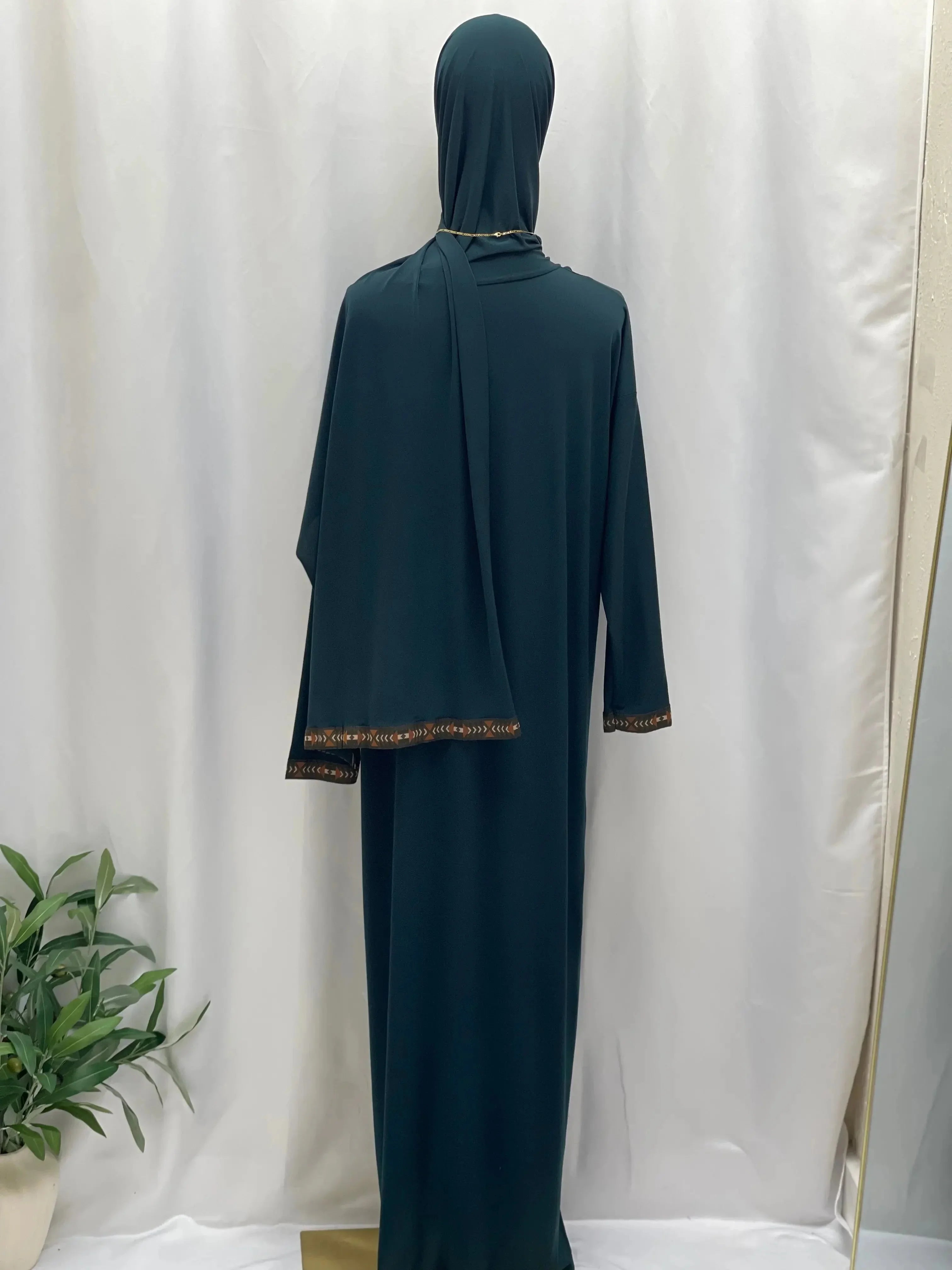 Palestinian Elegance dark green one piece prayer dress abaya with detailed trim on sleeves and head covering