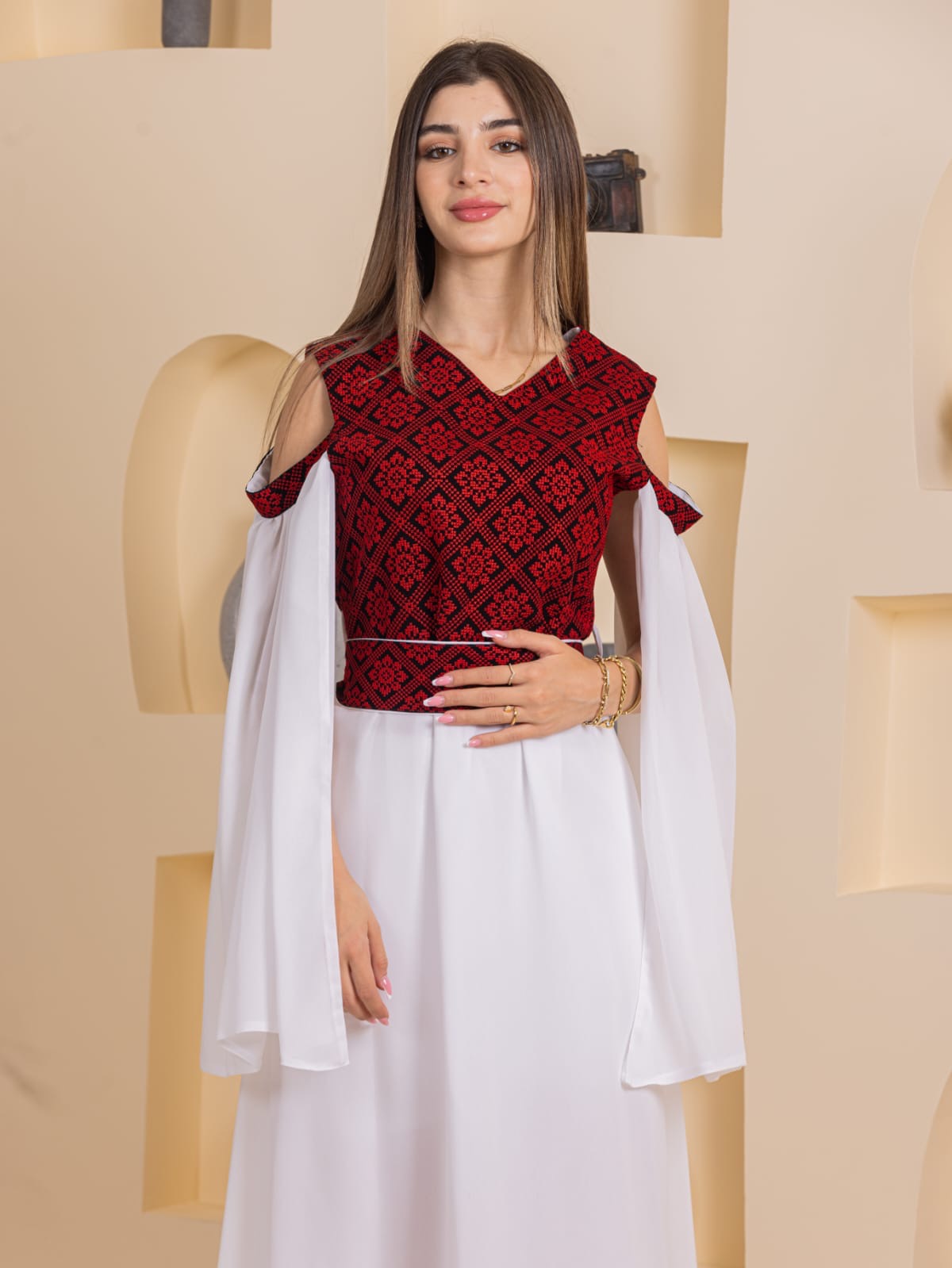 Model wearing Palestinian Essence Dress by Palestinian Elegance white skirt red with flowing sleeves
