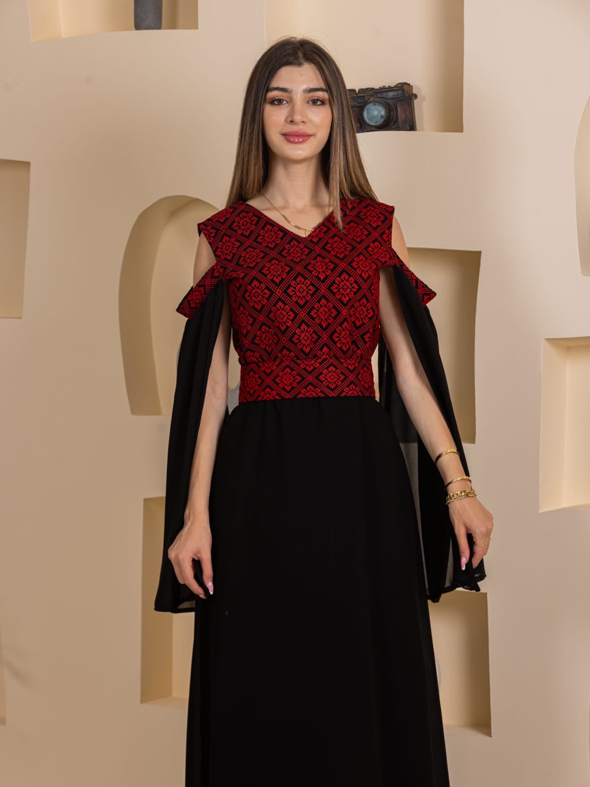 Palestinian Essence Dress by Palestinian Elegance red embroidered bodice black floor length gown with cape sleeves