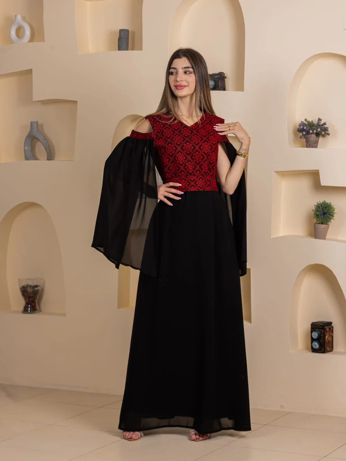 Palestinian Essence Dress by Palestinian Elegance long black gown with red embroidered bodice and sheer cape sleeves