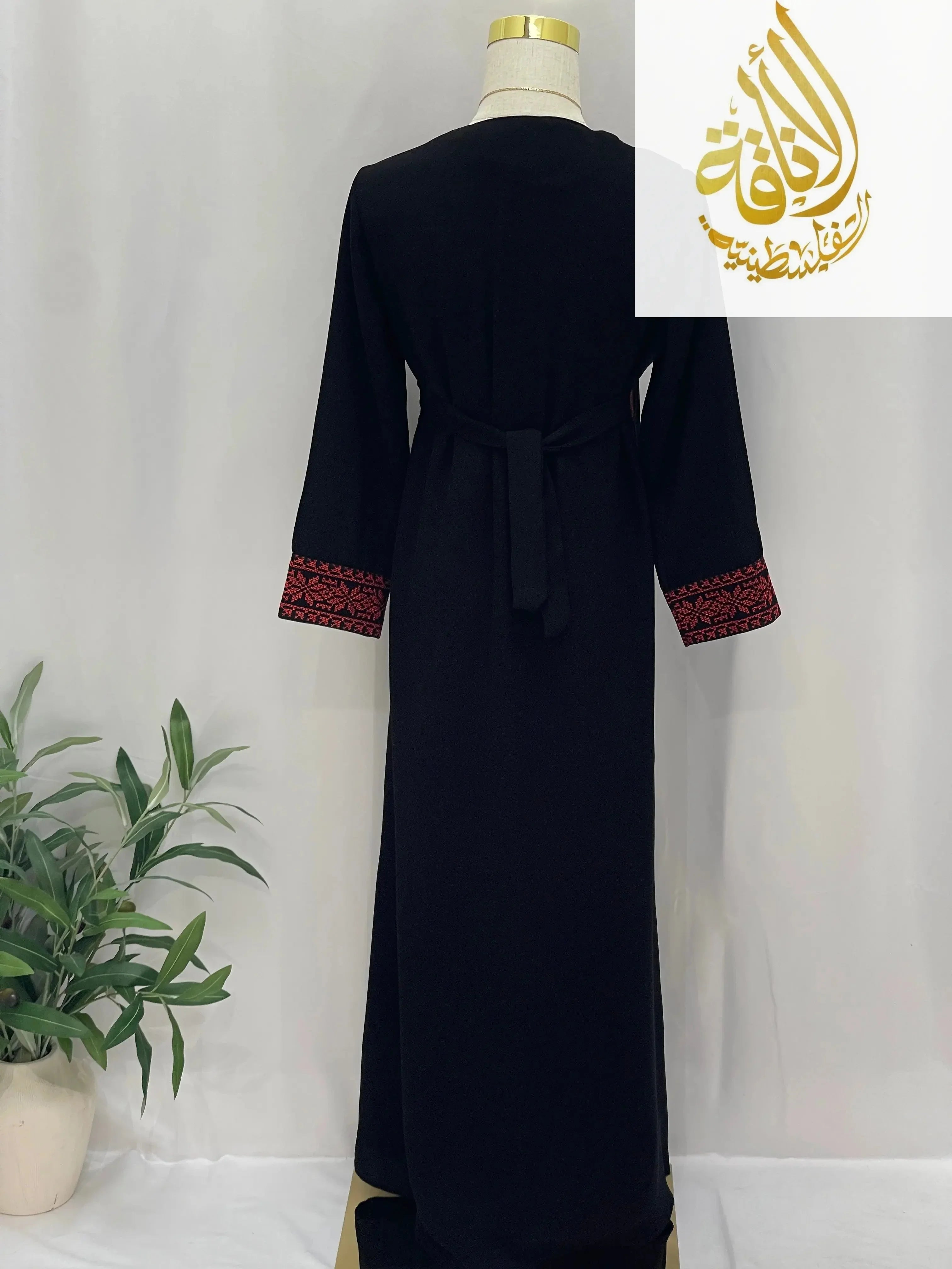 Back view of Palestinian Elegance kid's dress Haya Embroidered Abaya in black with red embroidered cuffs and waist tie