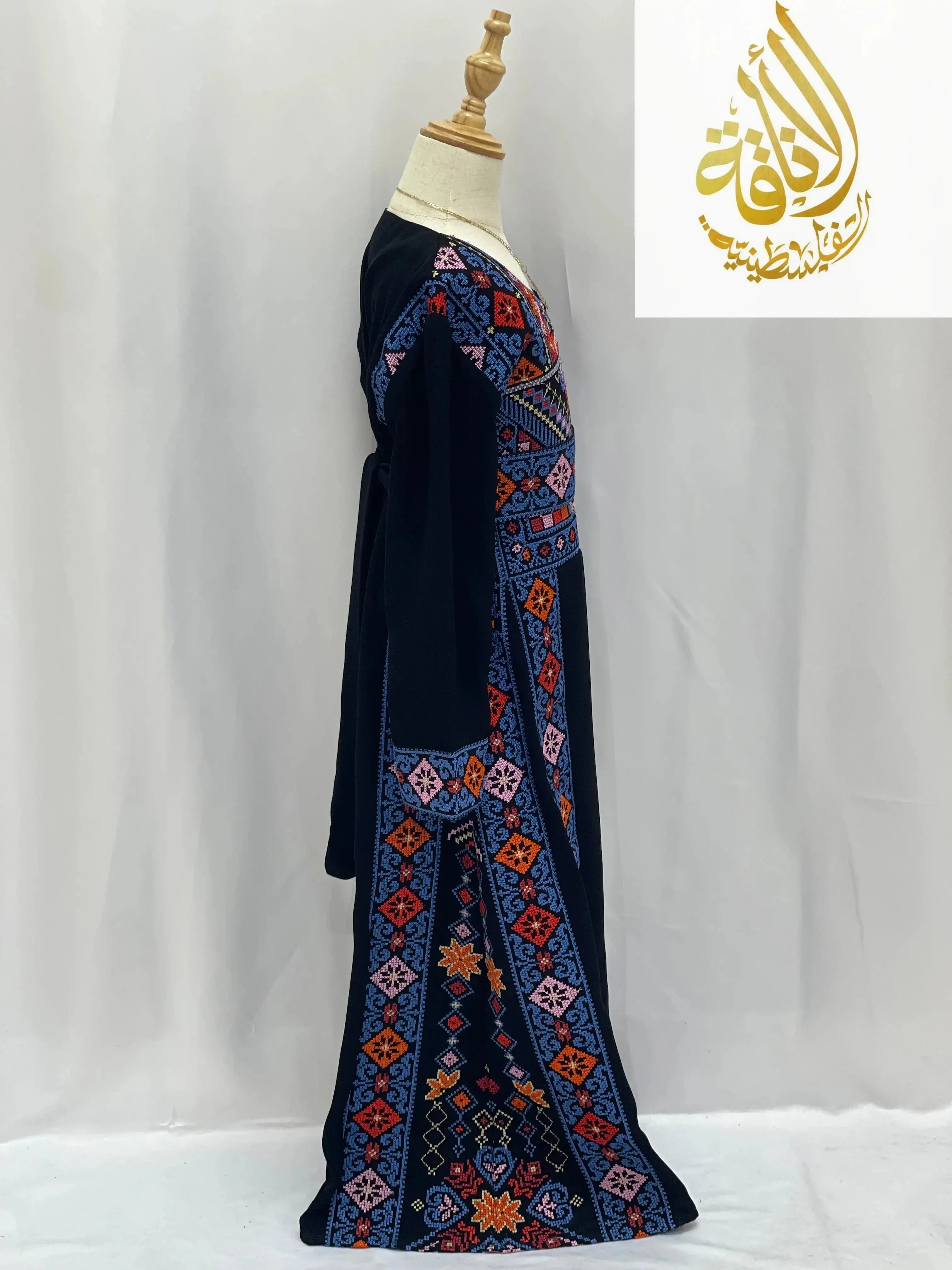 Palestinian Elegance embroidered thoub for girls with colorful geometric patterns on black fabric