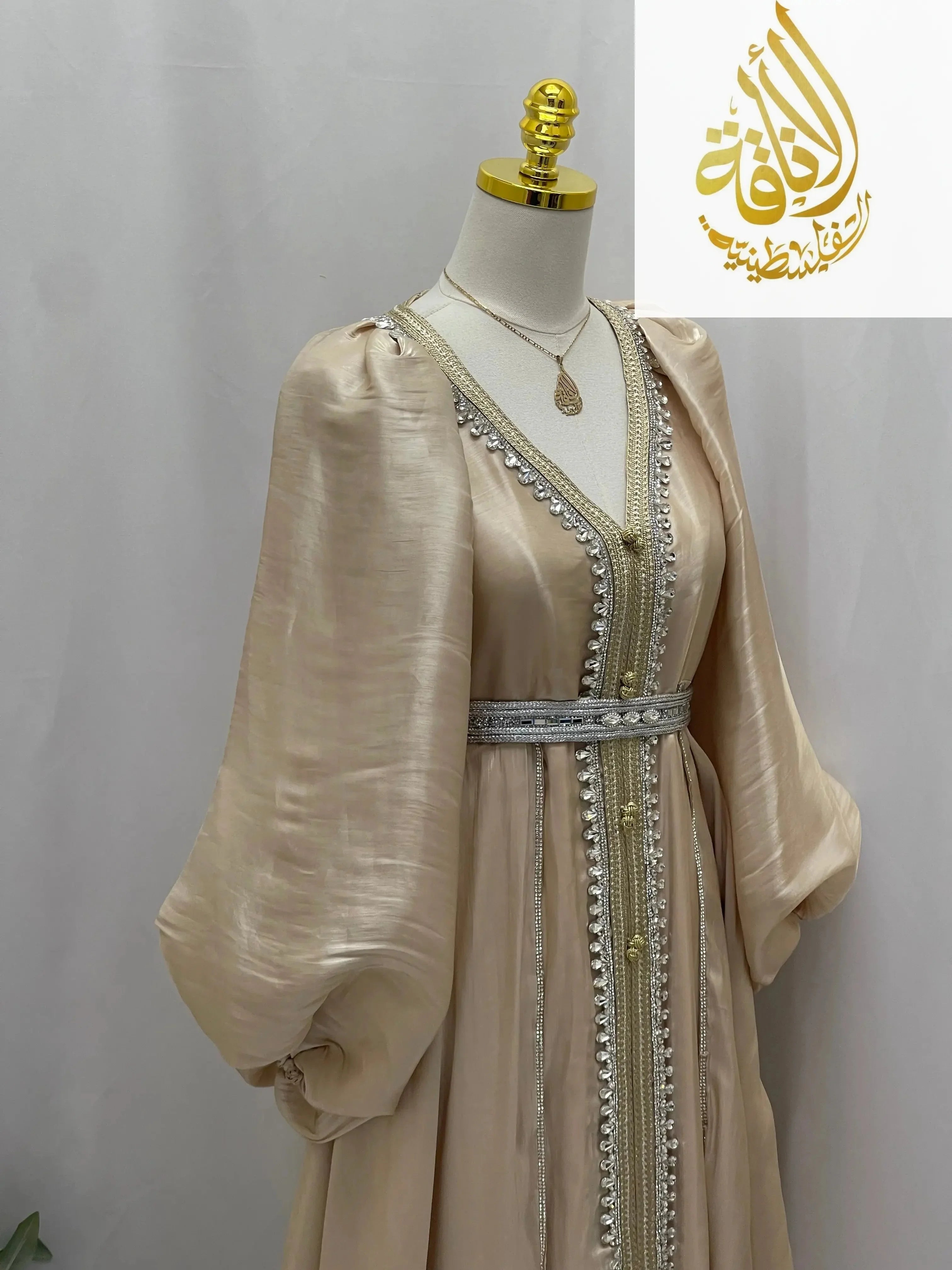 Palestinian Elegance puffy sleeves kaftan dress in beige with silver embroidery and beaded belt