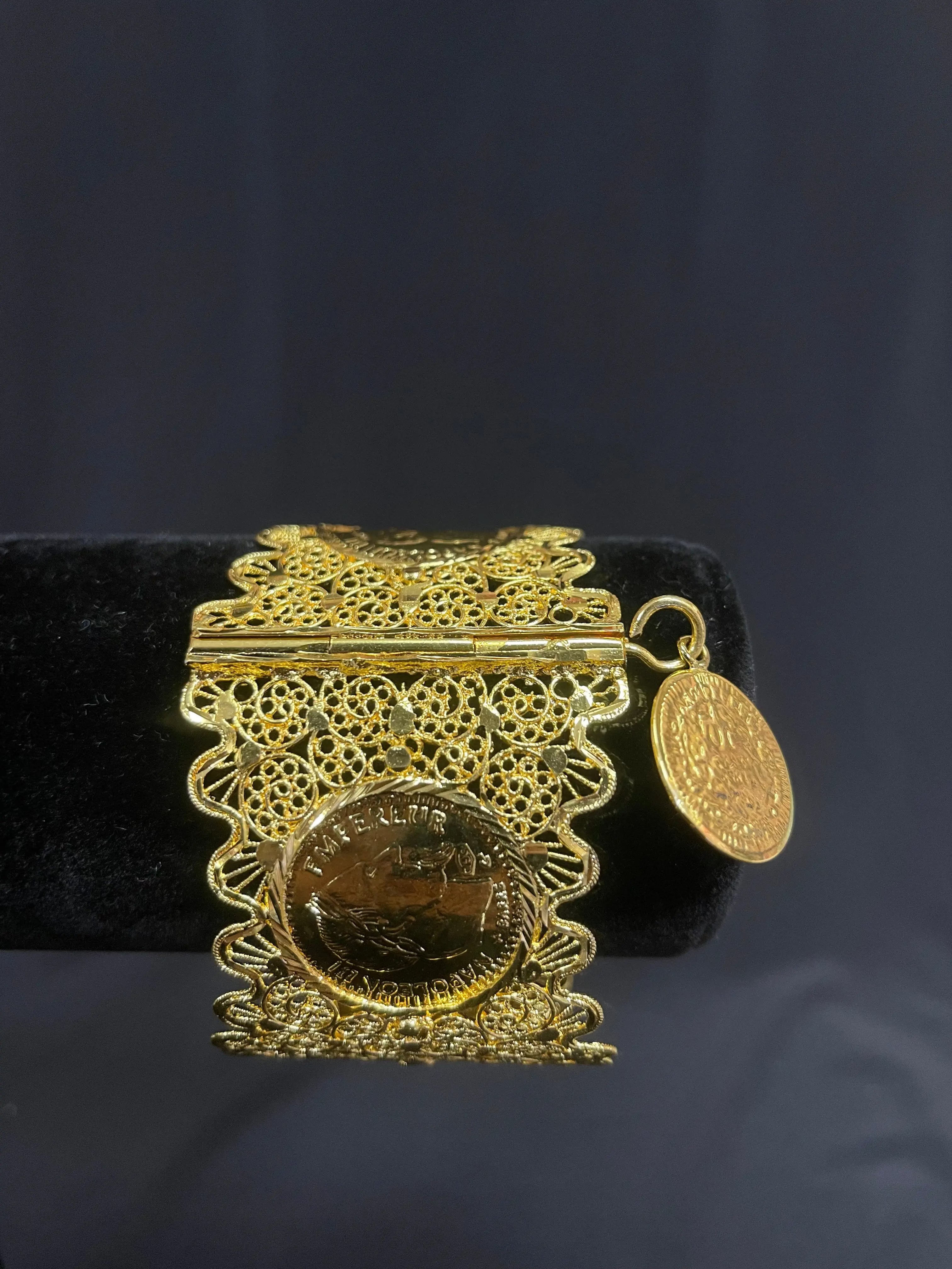 Qamar Bracelet in Imitated Gold by Palestinian Elegance with intricate filigree and coin charm detail