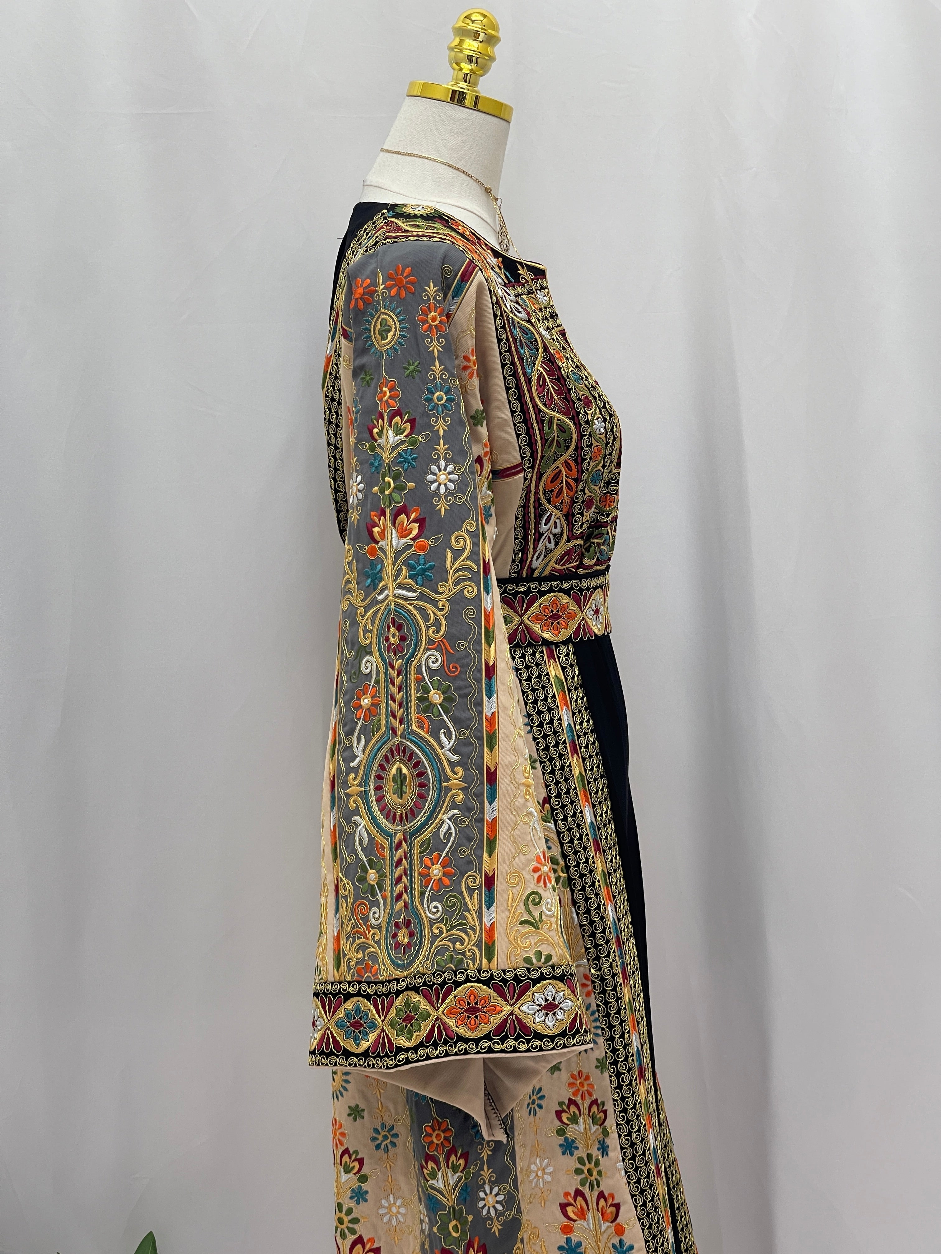 Rafif Embroidered Thobe by Palestinian Elegance side view on mannequin showing intricate multicolor Palestinian embroidery