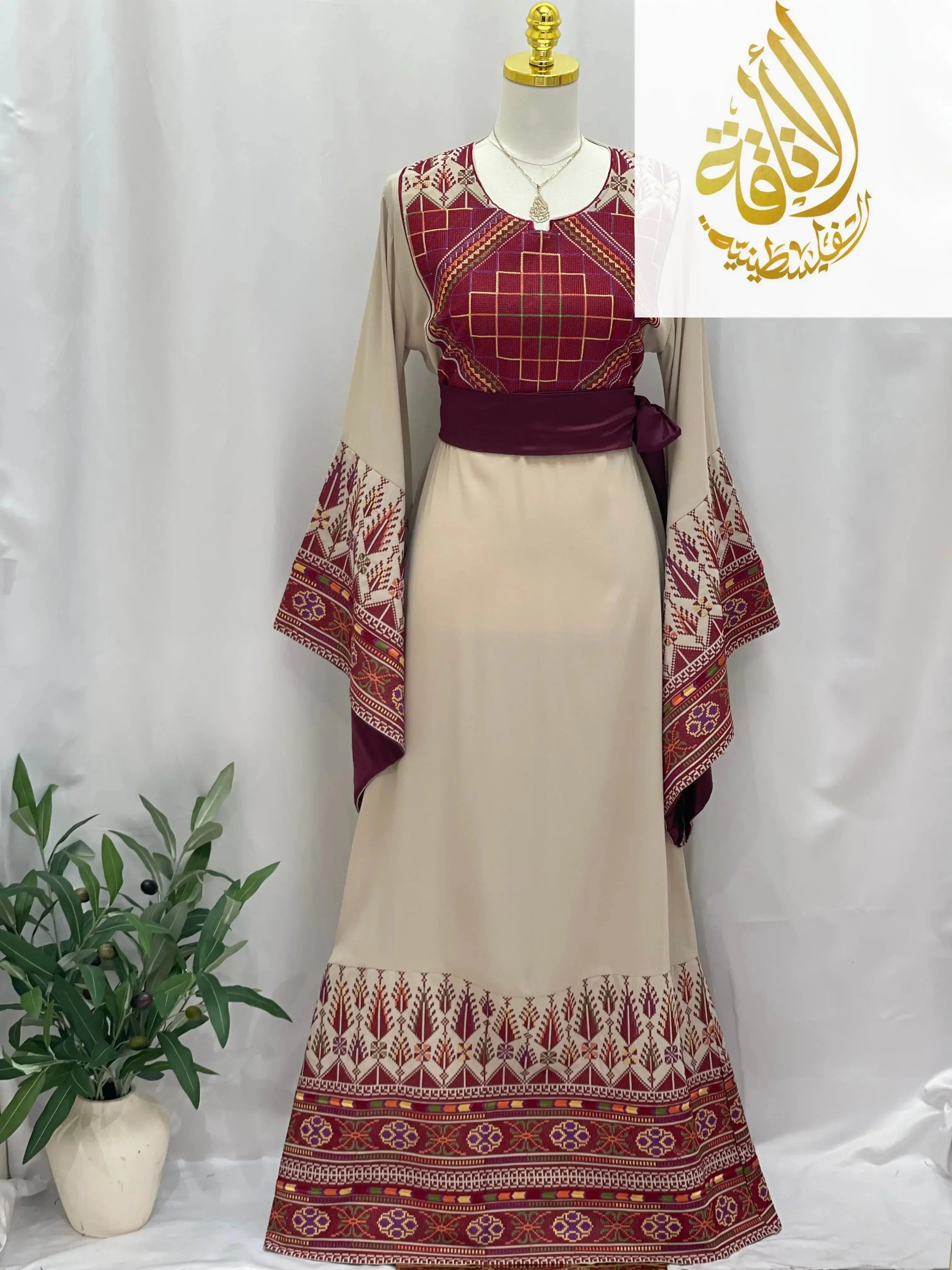 Randa Embroidered Thoub by Palestinian Elegance with intricate maroon and beige embroidery on sleeves and hem