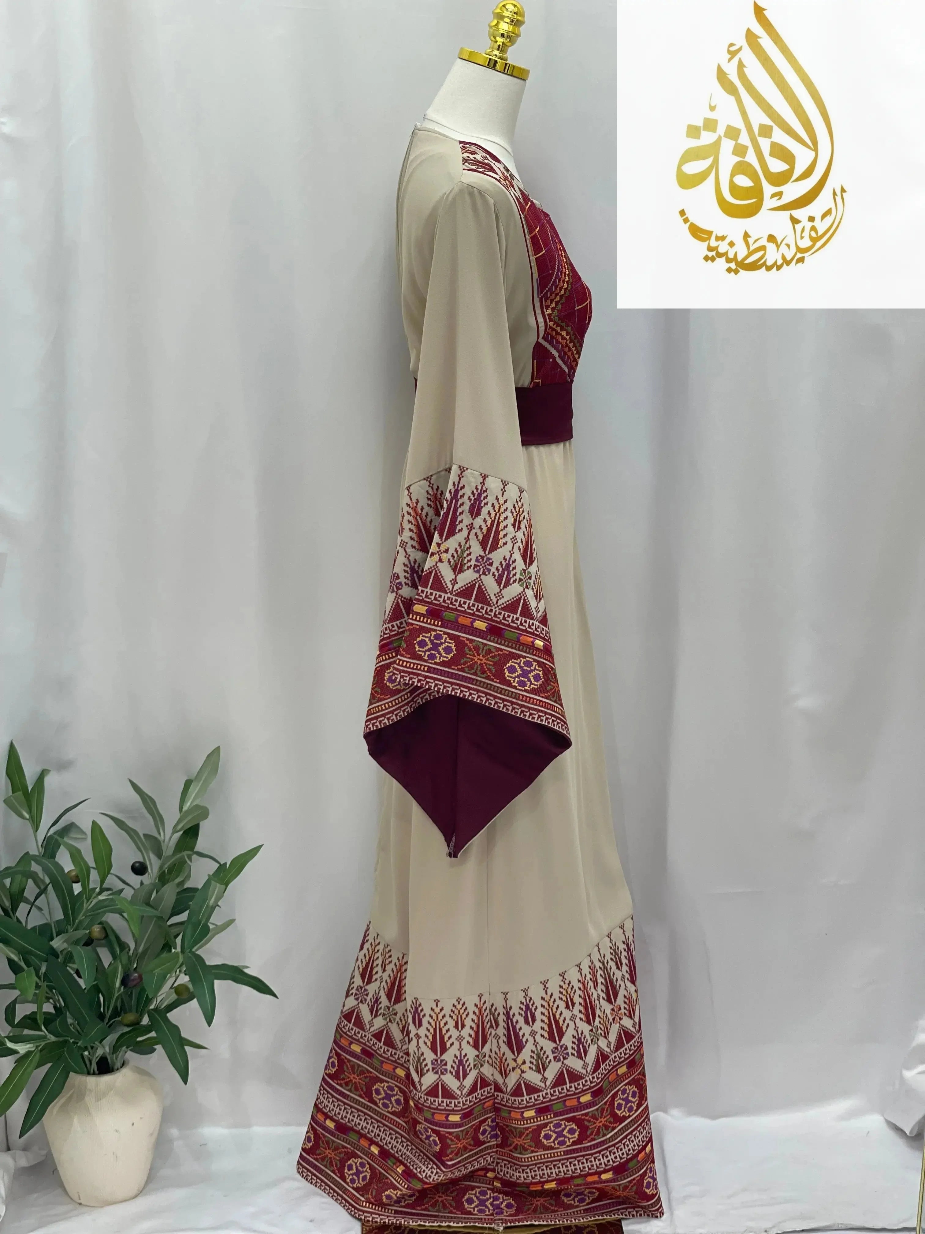 Randa Embroidered Thoub beige dress with intricate red and maroon embroidery on sleeves and hem by Palestinian Elegance