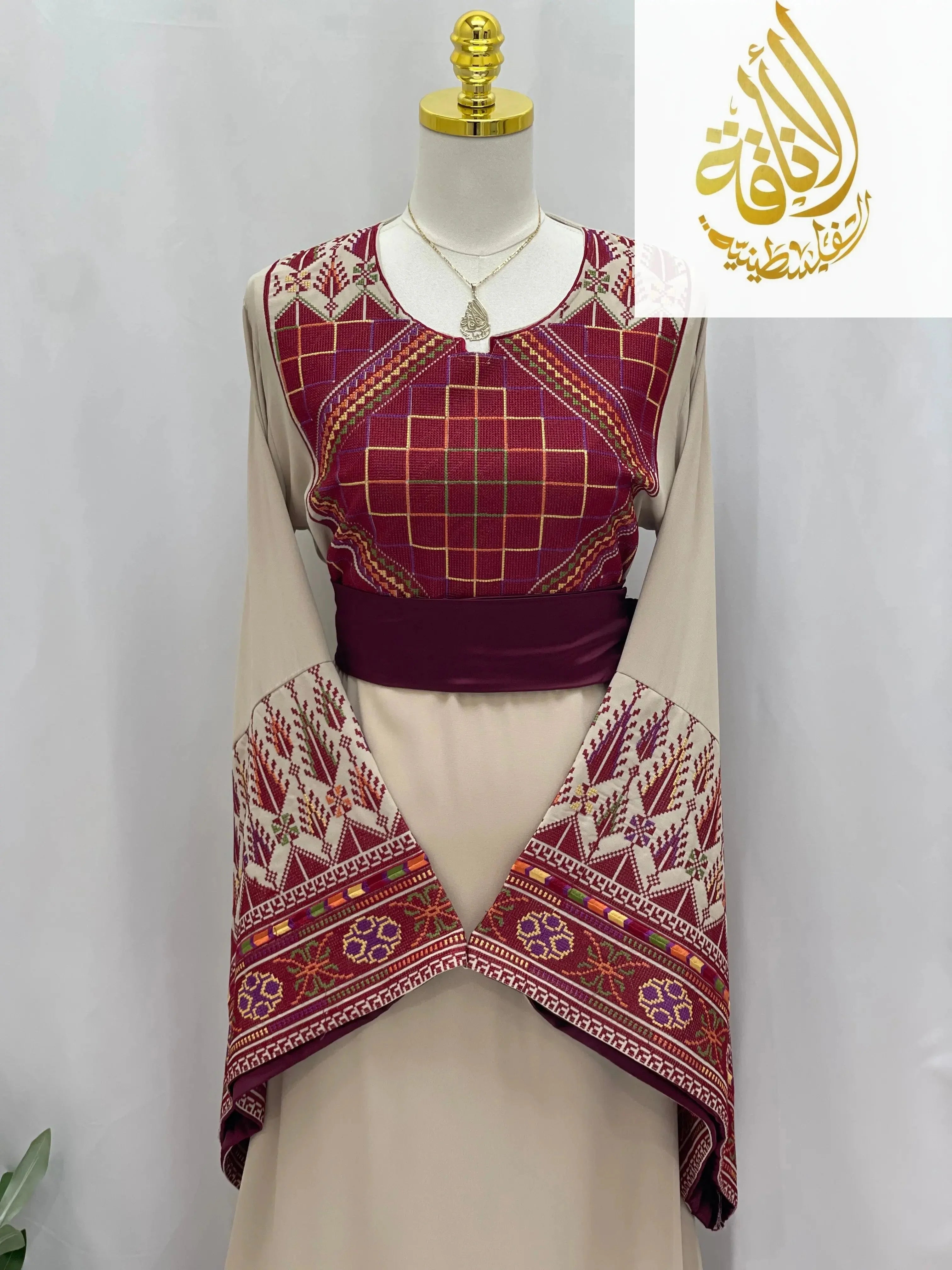 Randa Embroidered Thoub by Palestinian Elegance in beige with intricate red and maroon embroidery and wide sleeves