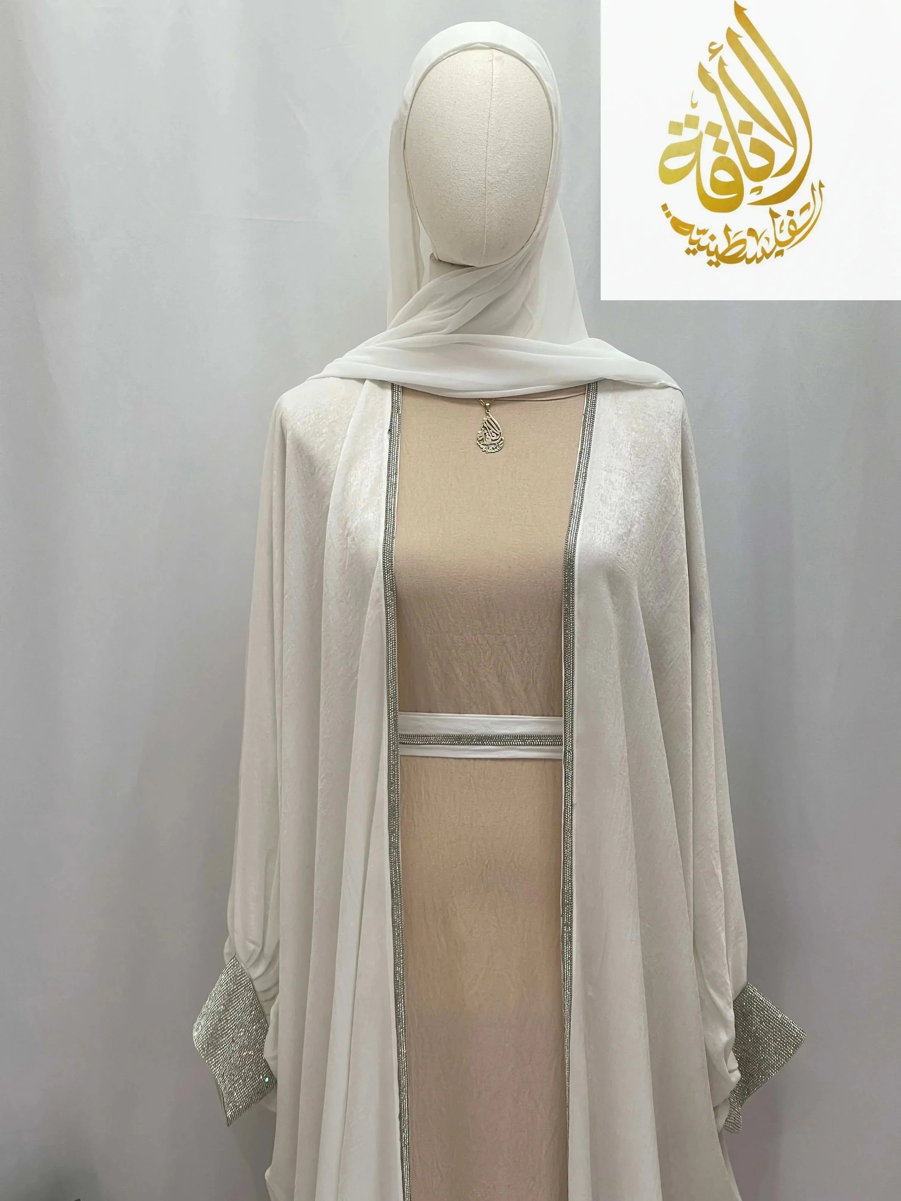 Randa modern open abaya in white with silver detailing on cuffs and edging from Palestinian Elegance