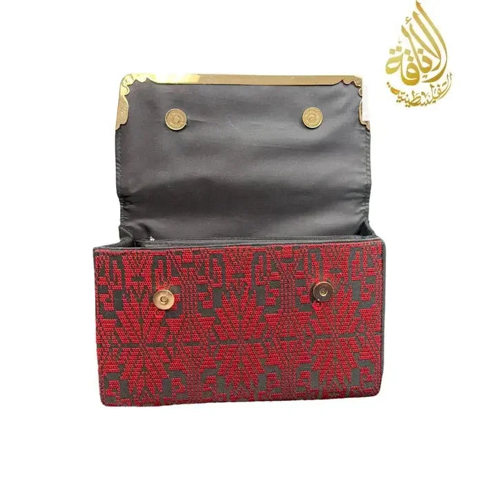 Open red kuffiyeh handbag with black interior and gold-tone snap buttons from Palestinian Elegance