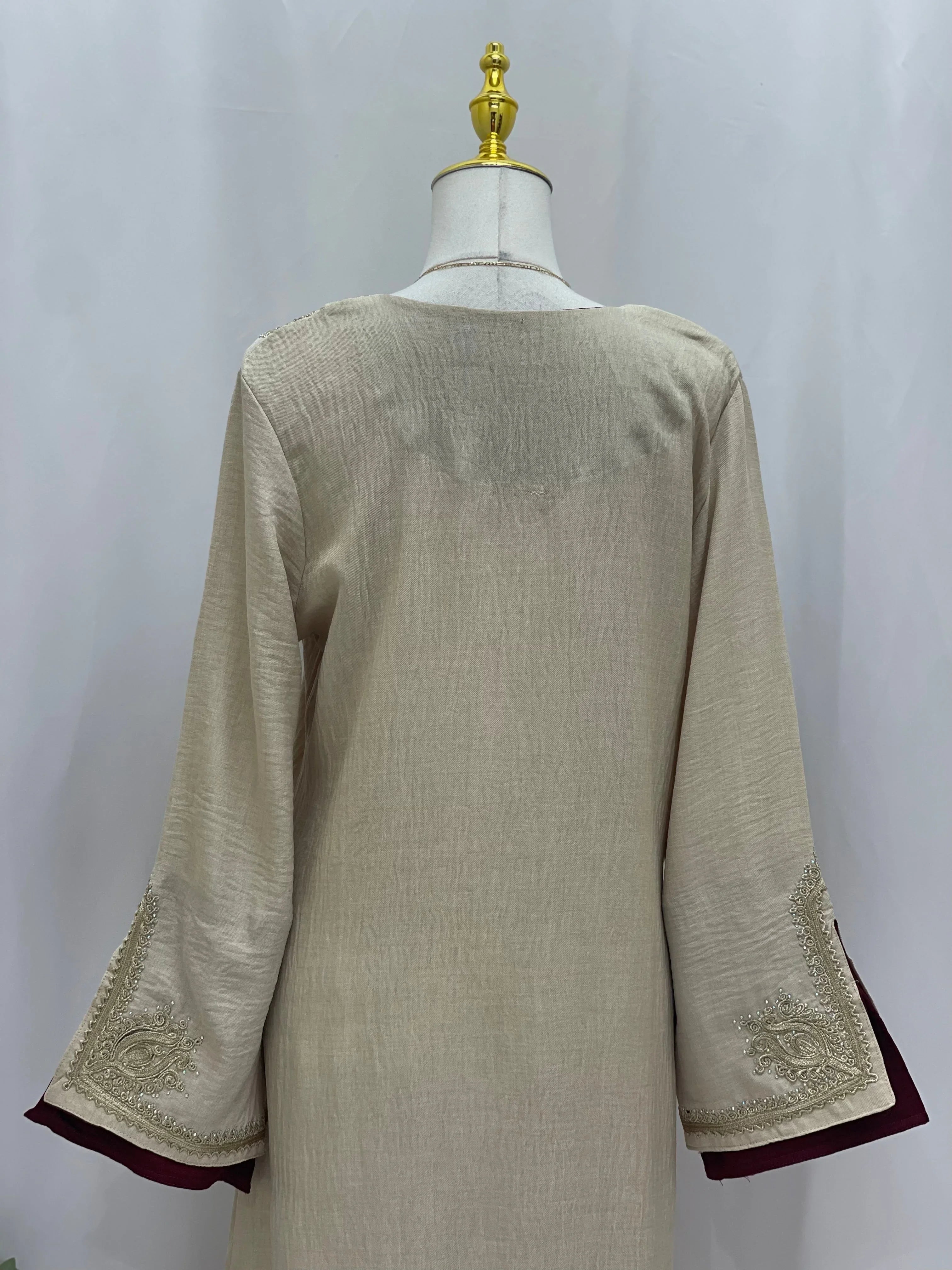 Regal Moroccan Jalabiya beige linen back view on mannequin with embroidered bell sleeves and burgundy trim