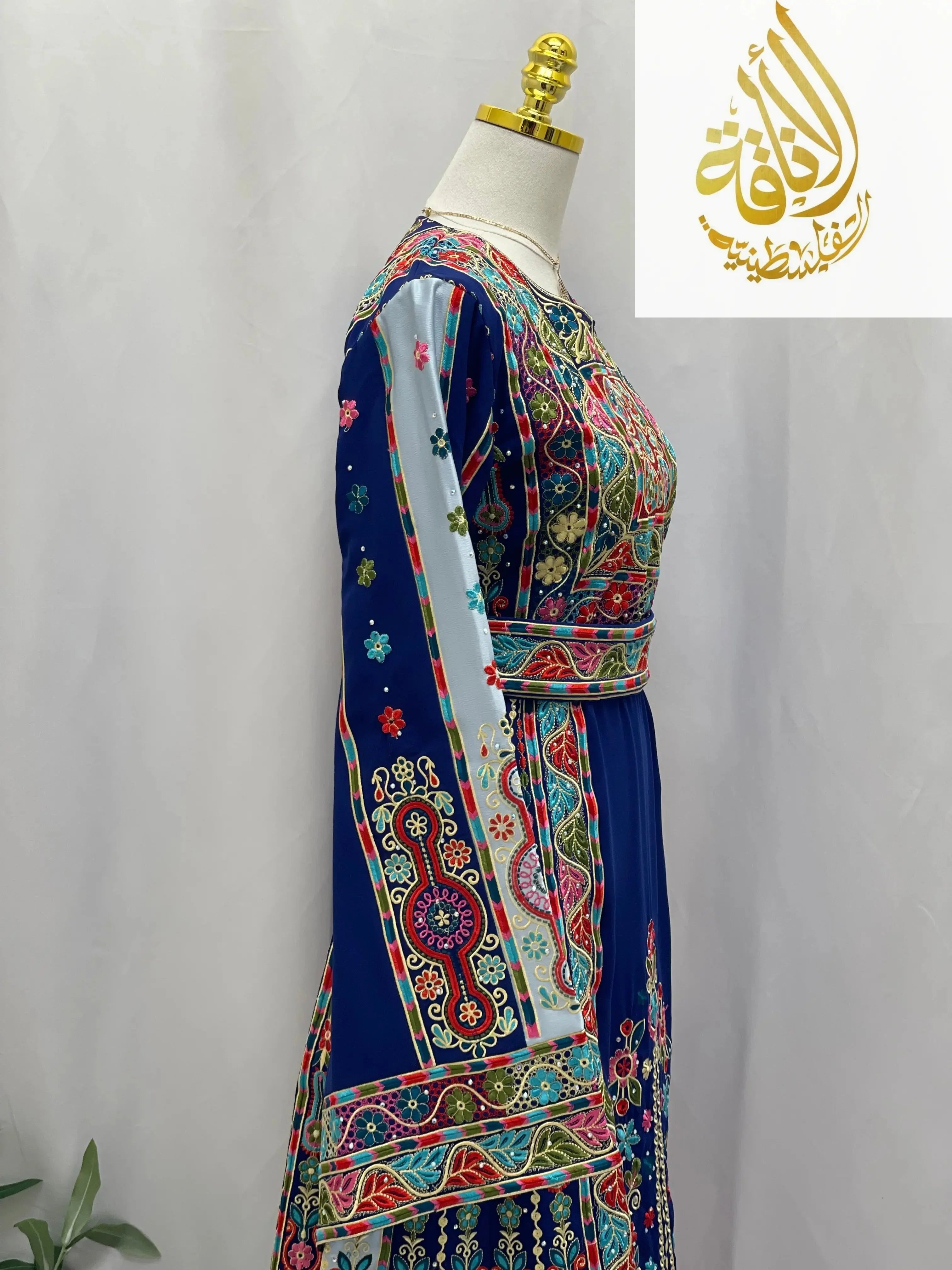 Royal blue embroidered thoub with detailed multicolor traditional Palestinian embroidery on mannequin
