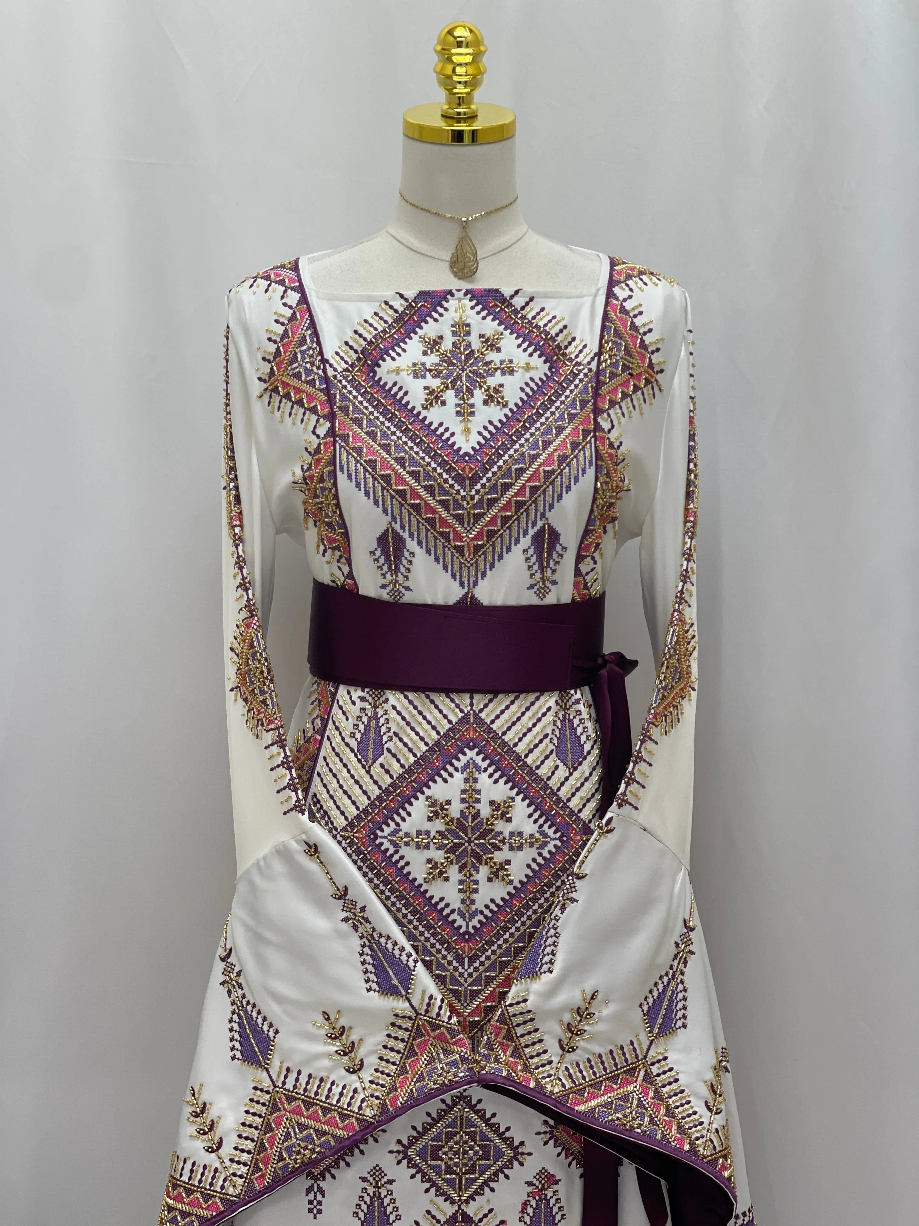 Palestinian Elegance bridal Embroidered Thoub Gown white silk style with purple and gold geometric embroidery and burgundy sash