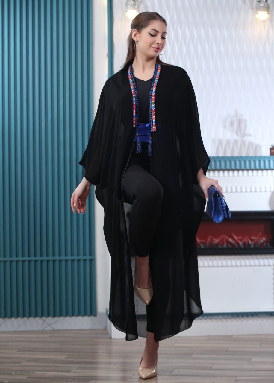 Palestinian Elegance black embroidered chiffon cardigan with colorful trim worn by model
