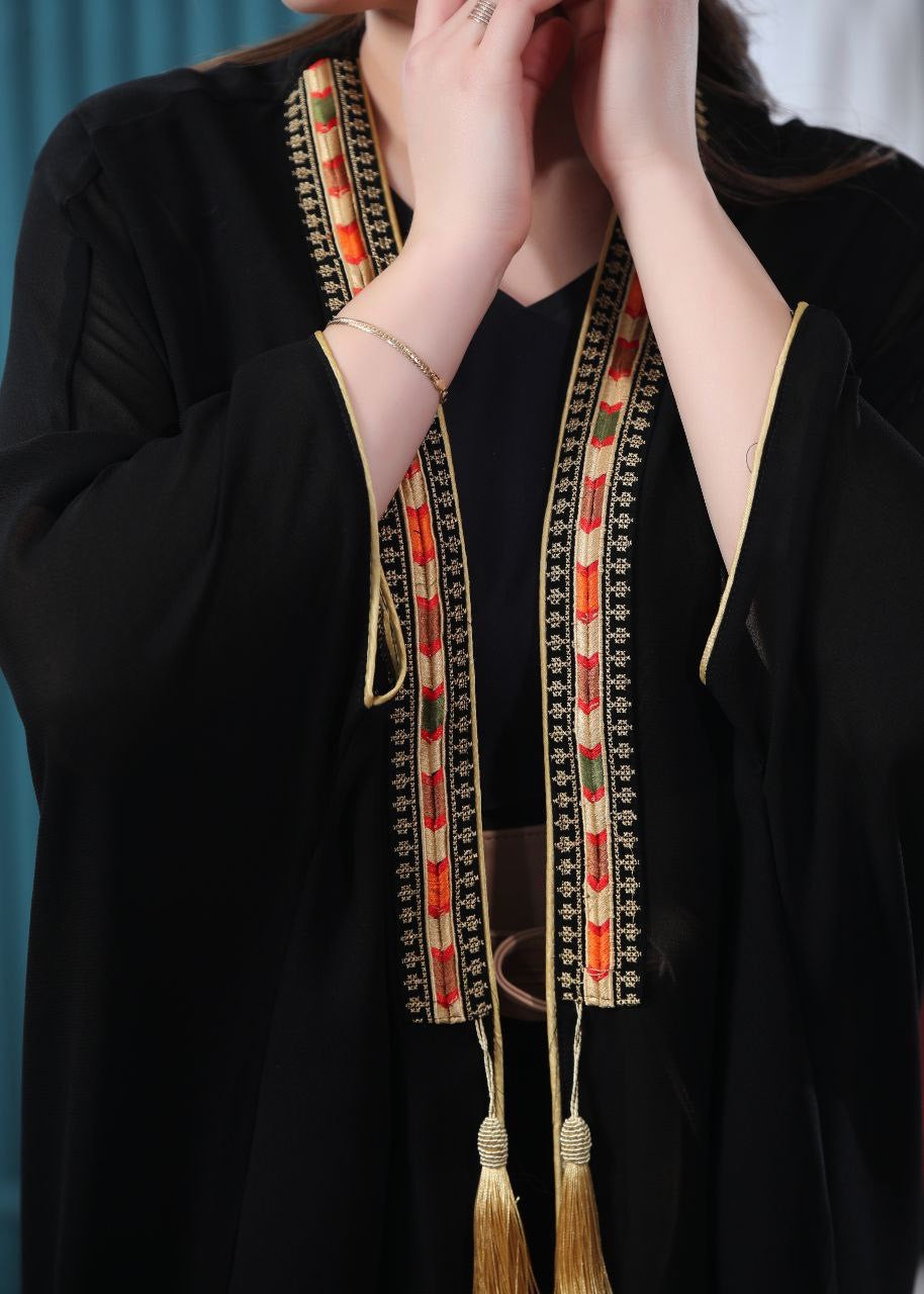 Black embroidered chiffon cardigan by Palestinian Elegance with intricate colorful embroidery and tassel details