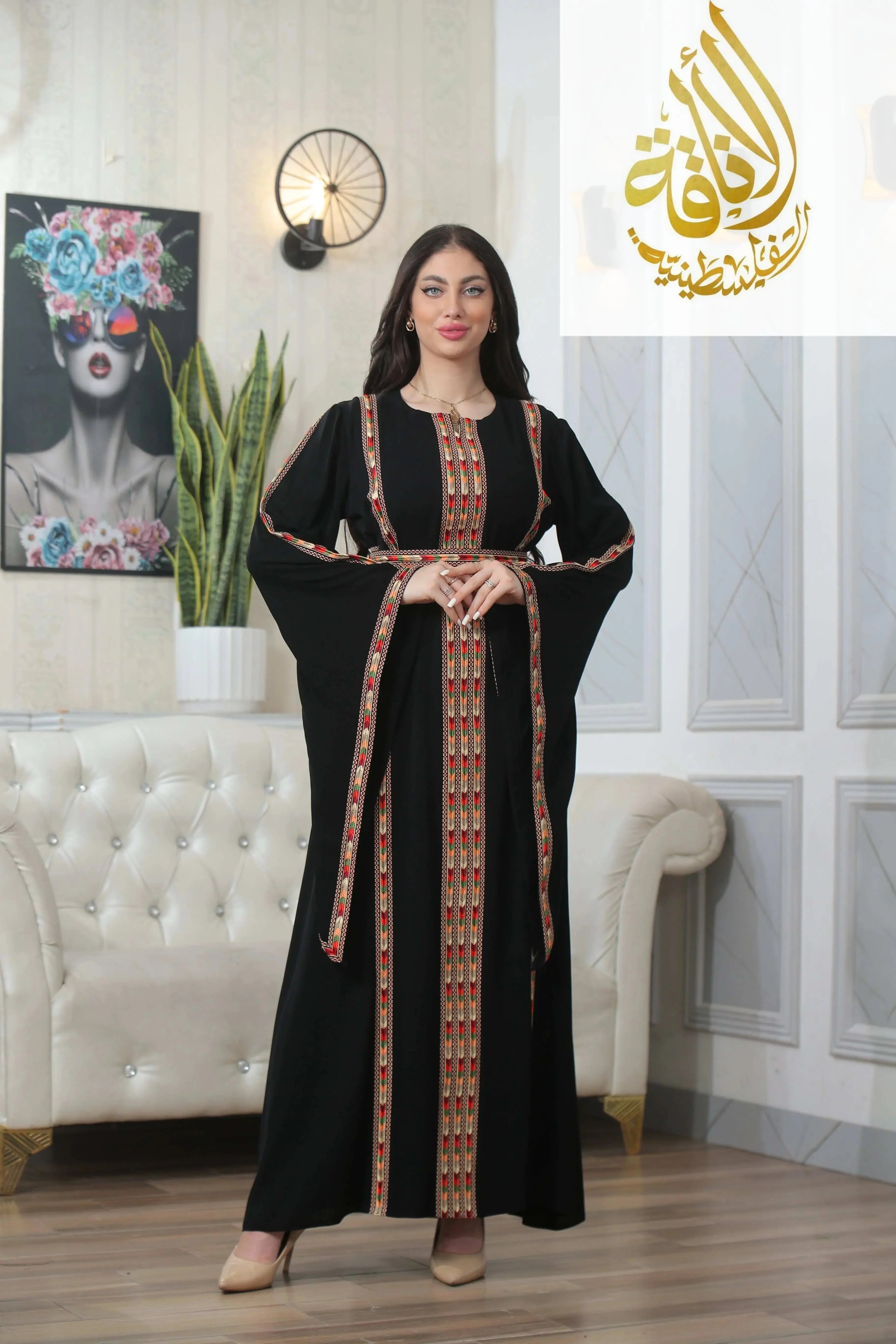 Woman wearing Palestinian Elegance Salam Manjal Embroidered Thoub black traditional dress with red and gold embroidery