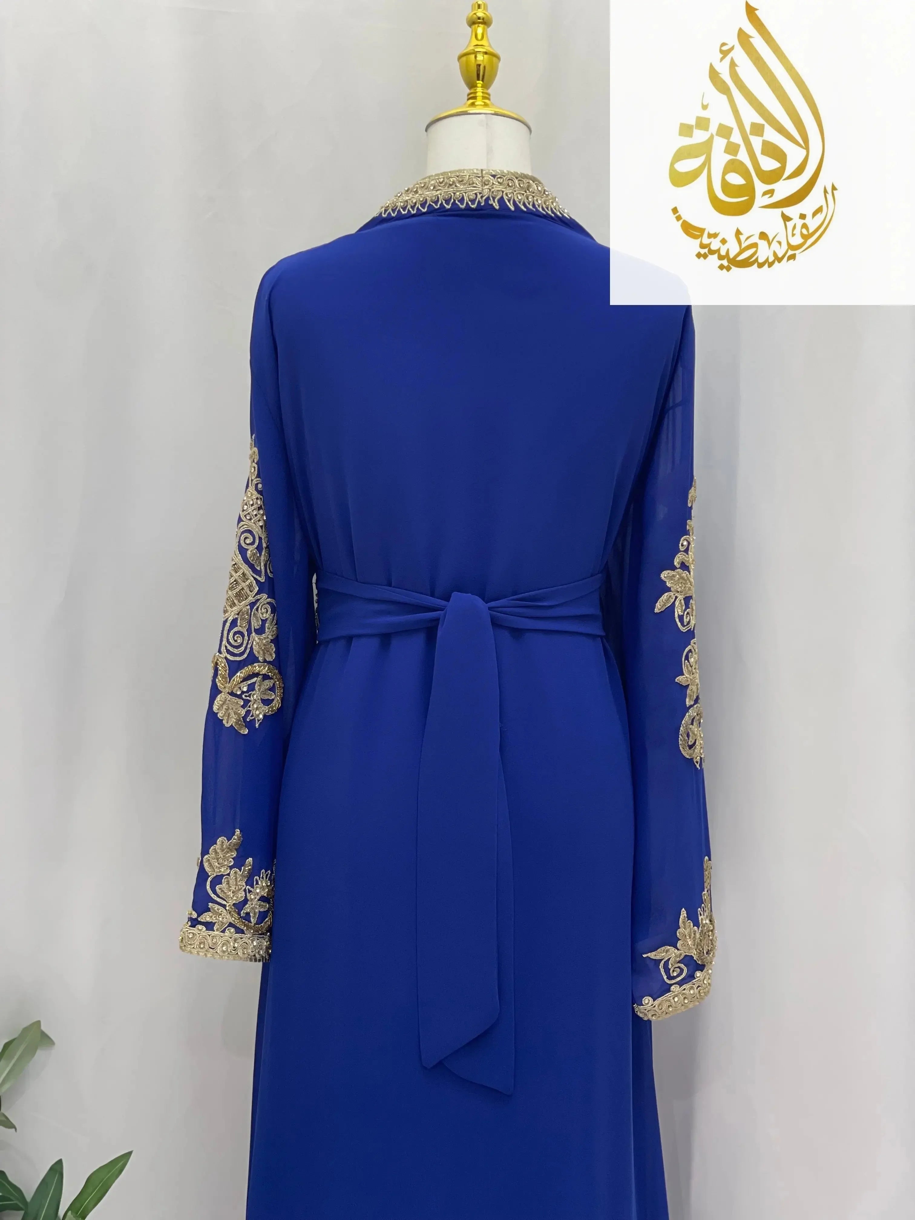 Back view of Palestinian Elegance Moroccan Style Kaftan in royal blue with gold embroidery and waist tie