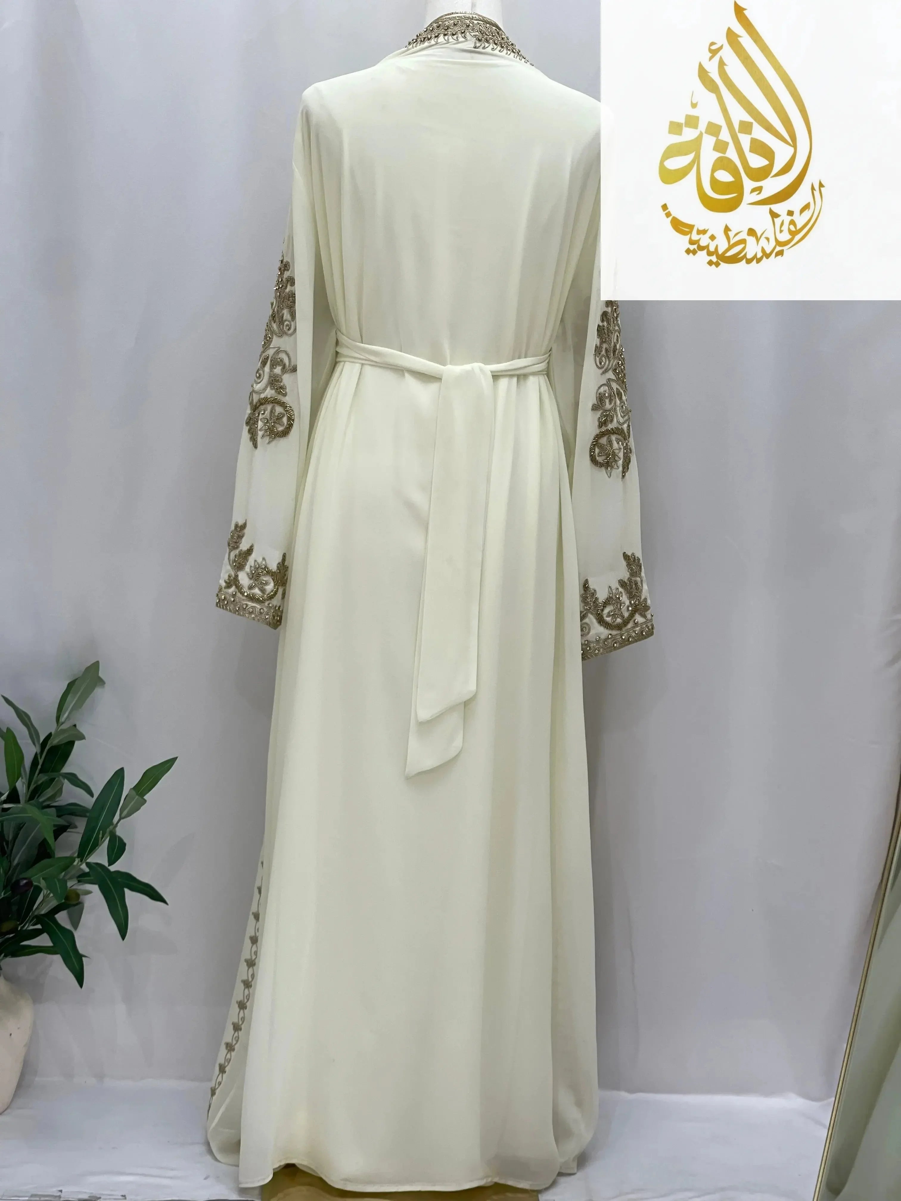 Palestinian Elegance Moroccan Style Kaftan in white with gold embroidery on sleeves and belt at the back