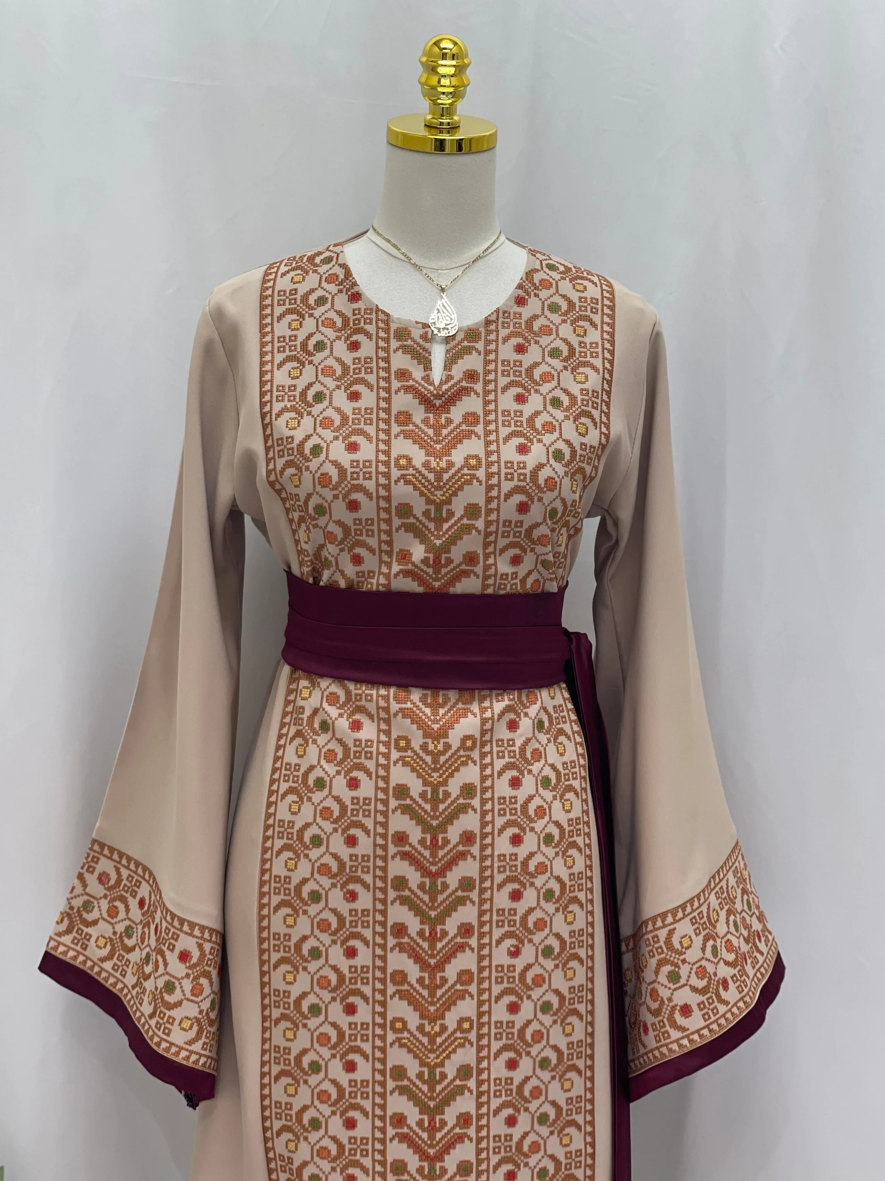 Palestinian Elegance Embroiderd Thobe With Belt in beige with brown embroidery and maroon waist belt