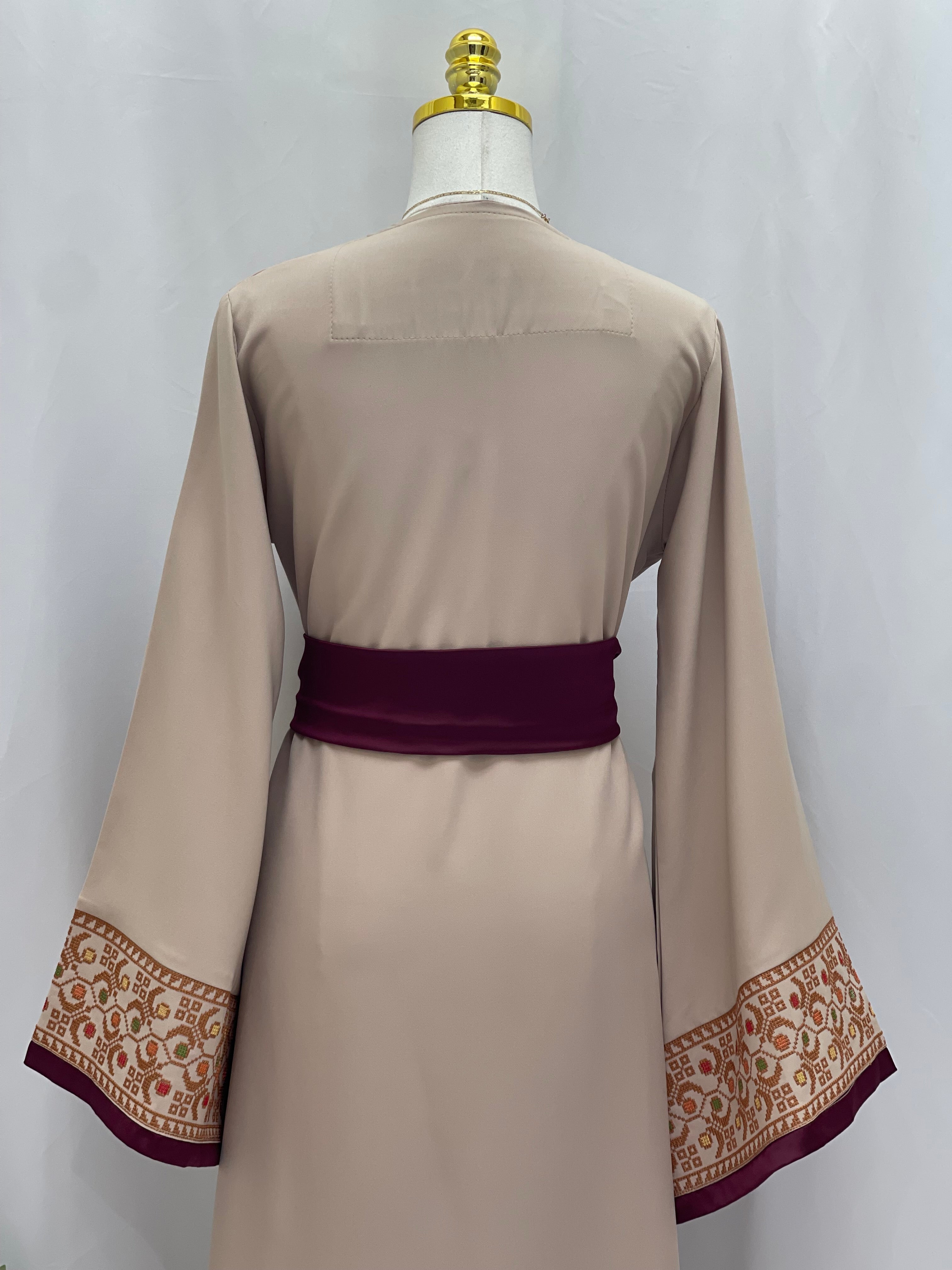 Back view of Embroiderd Thobe With Belt featuring intricate sleeve embroidery and a deep purple belt
