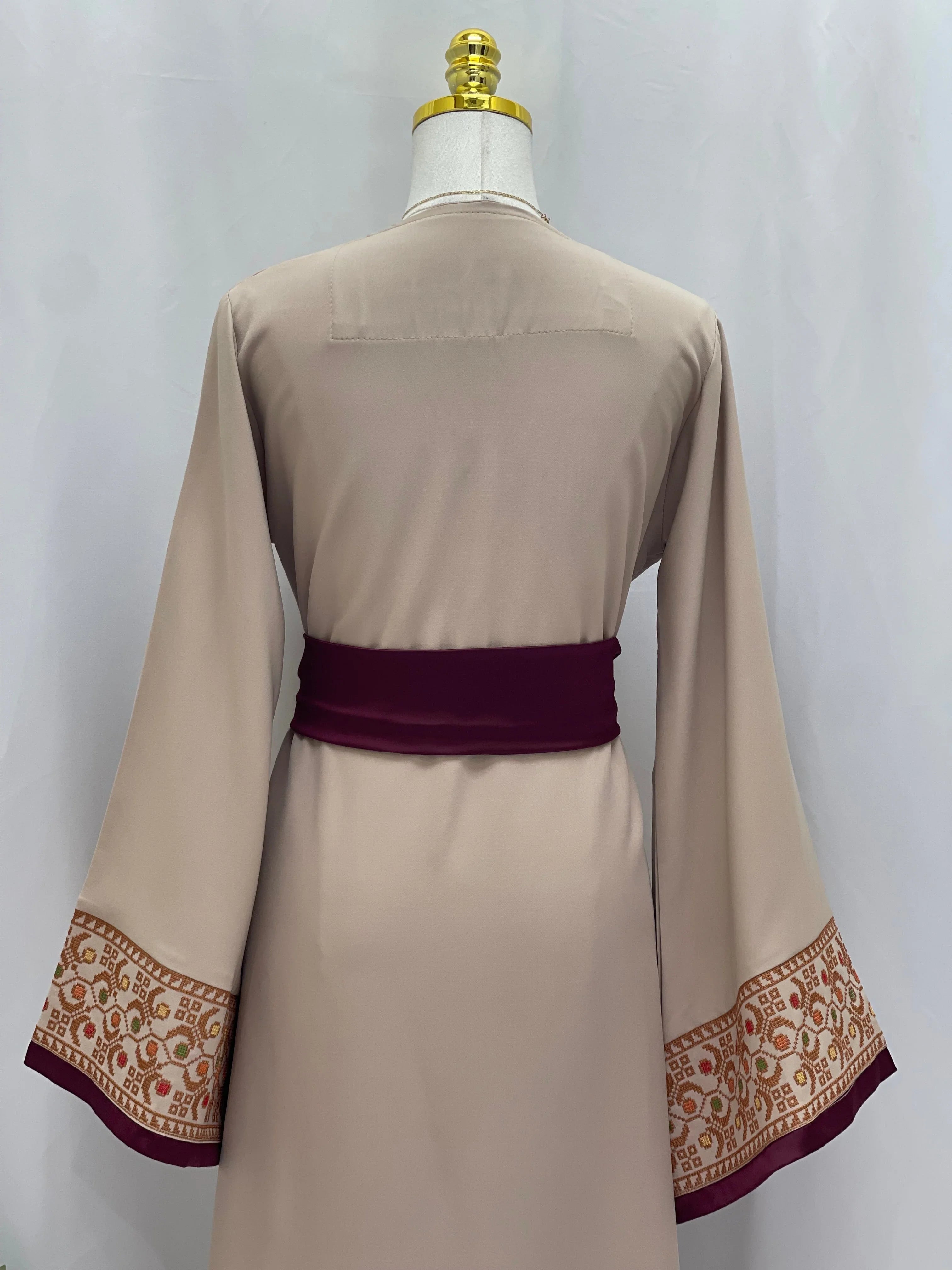 Back view of Embroiderd Thobe With Belt featuring intricate sleeve embroidery and a deep purple belt