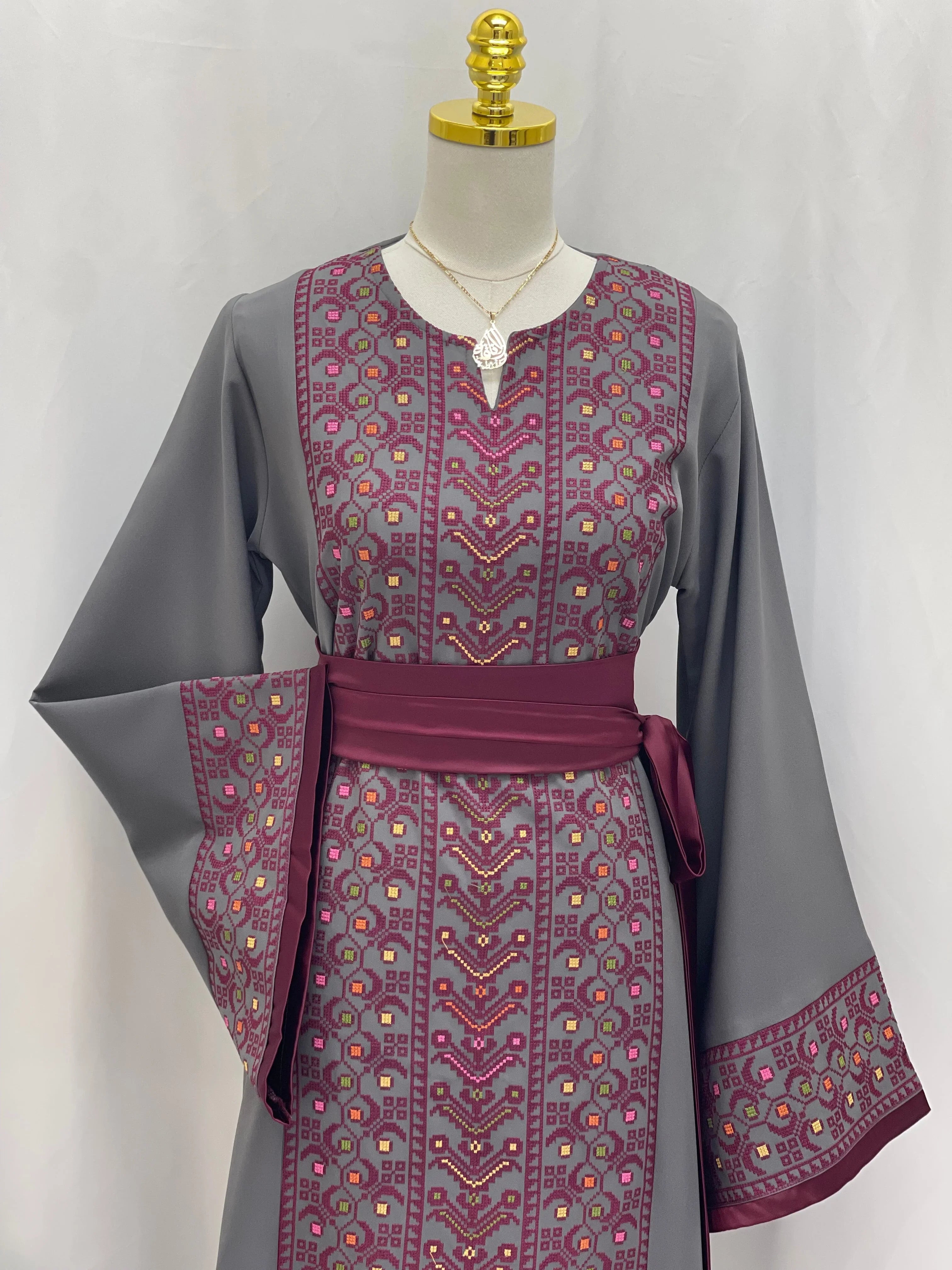 Palestinian Elegance Embroiderd Thobe With Belt in gray and purple detailed with intricate embroidery on front and sleeves