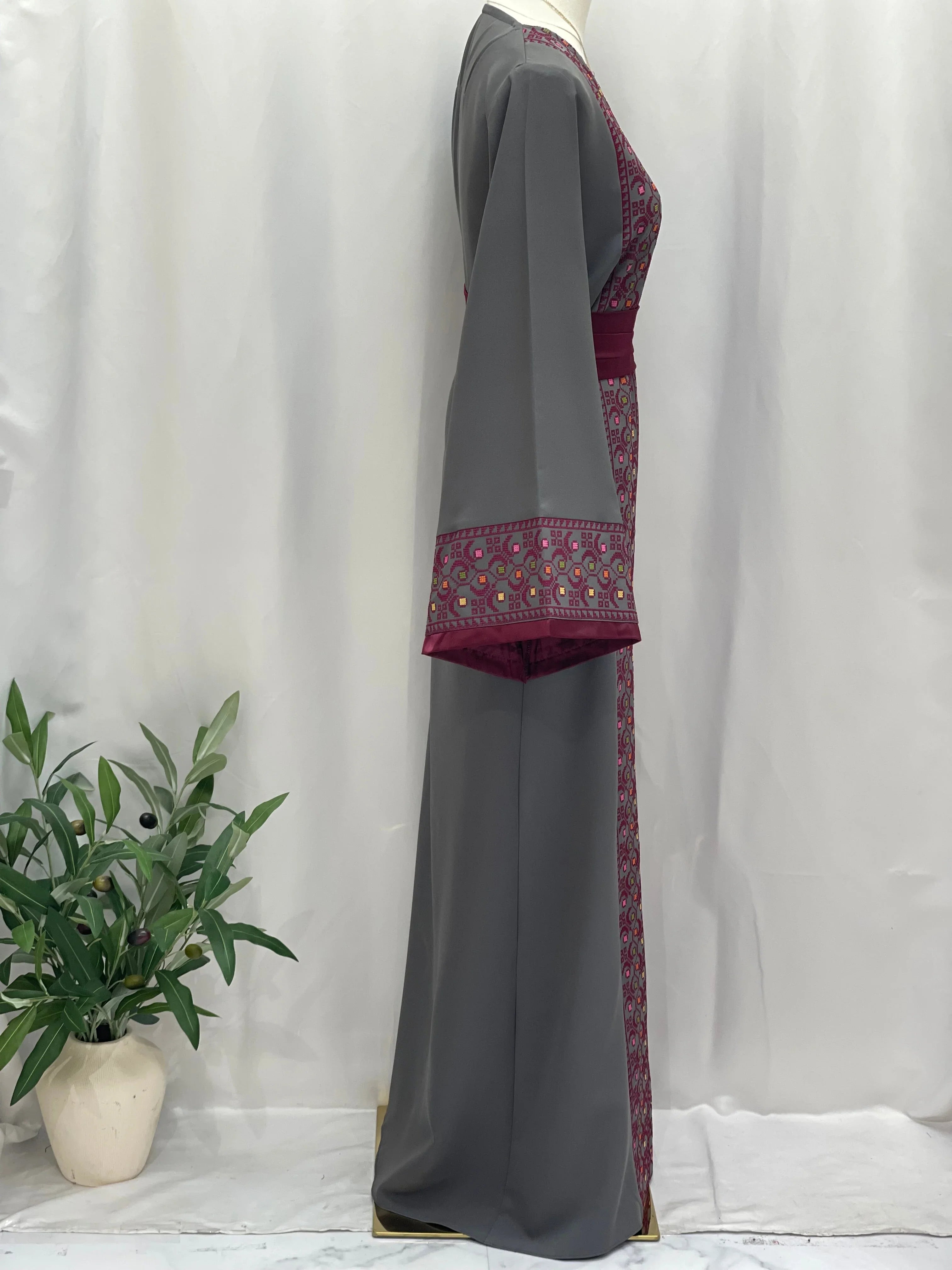 Side view of Palestinian Elegance Embroiderd Thobe With Belt in gray with intricate maroon embroidery
