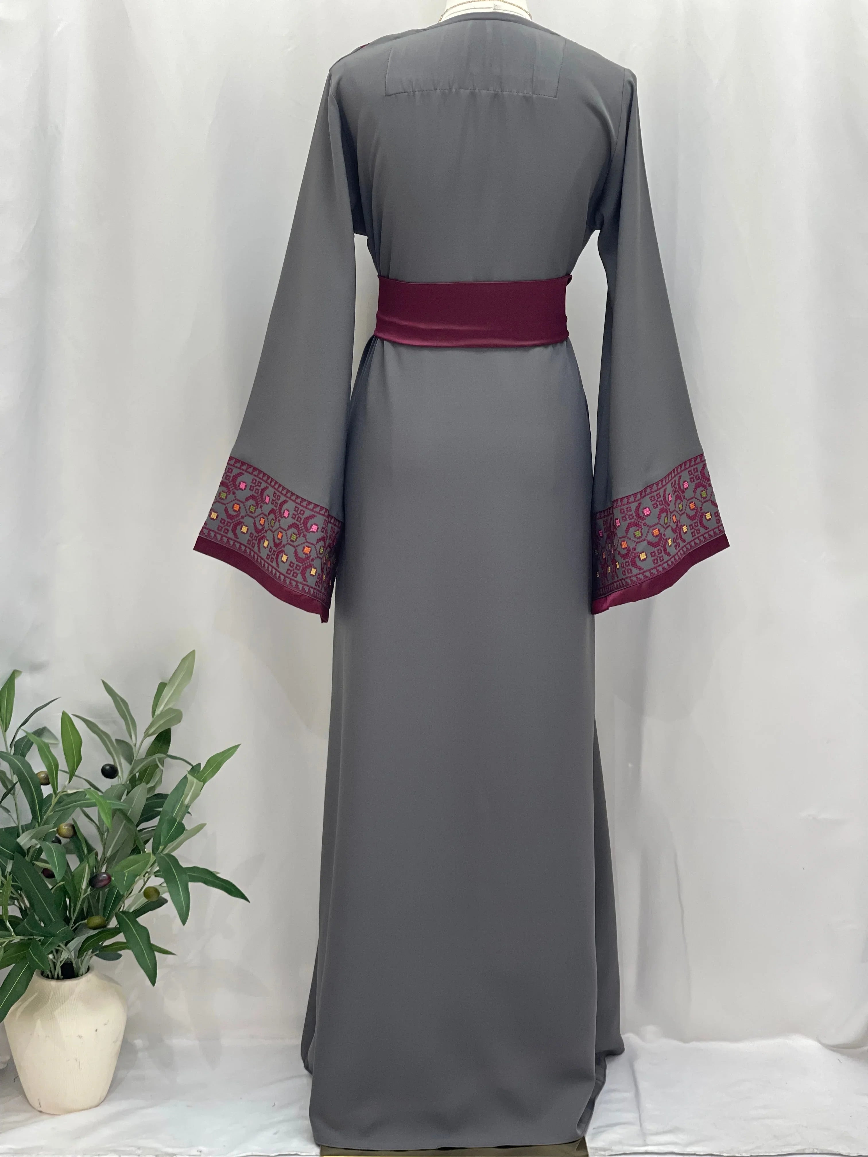 Back view of Embroiderd Thobe With Belt in gray with maroon embroidered cuffs and matching belt by Palestinian Elegance