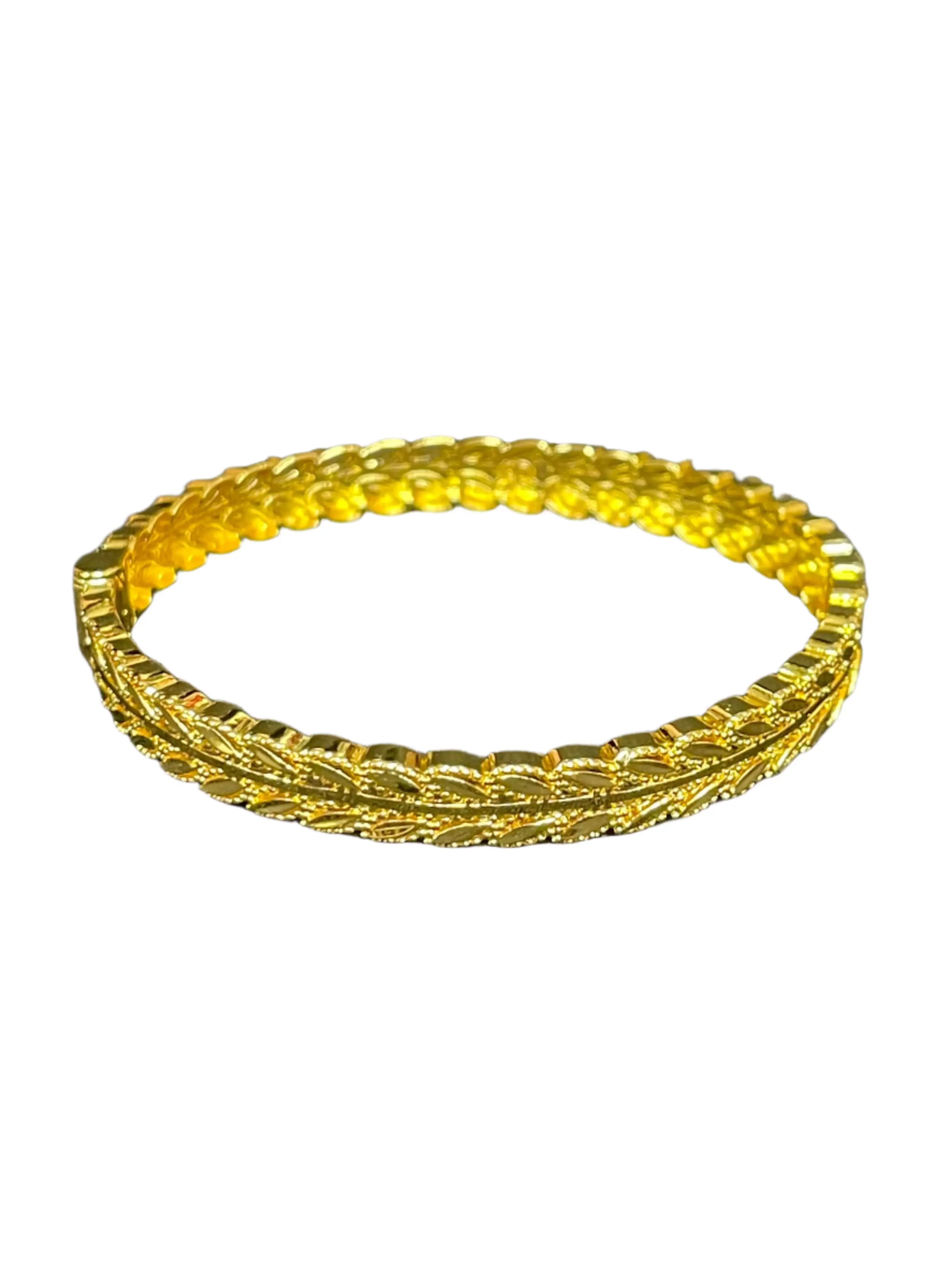 Palestinian Elegance imitation gold bangle bracelet with intricate textured design and shiny finish