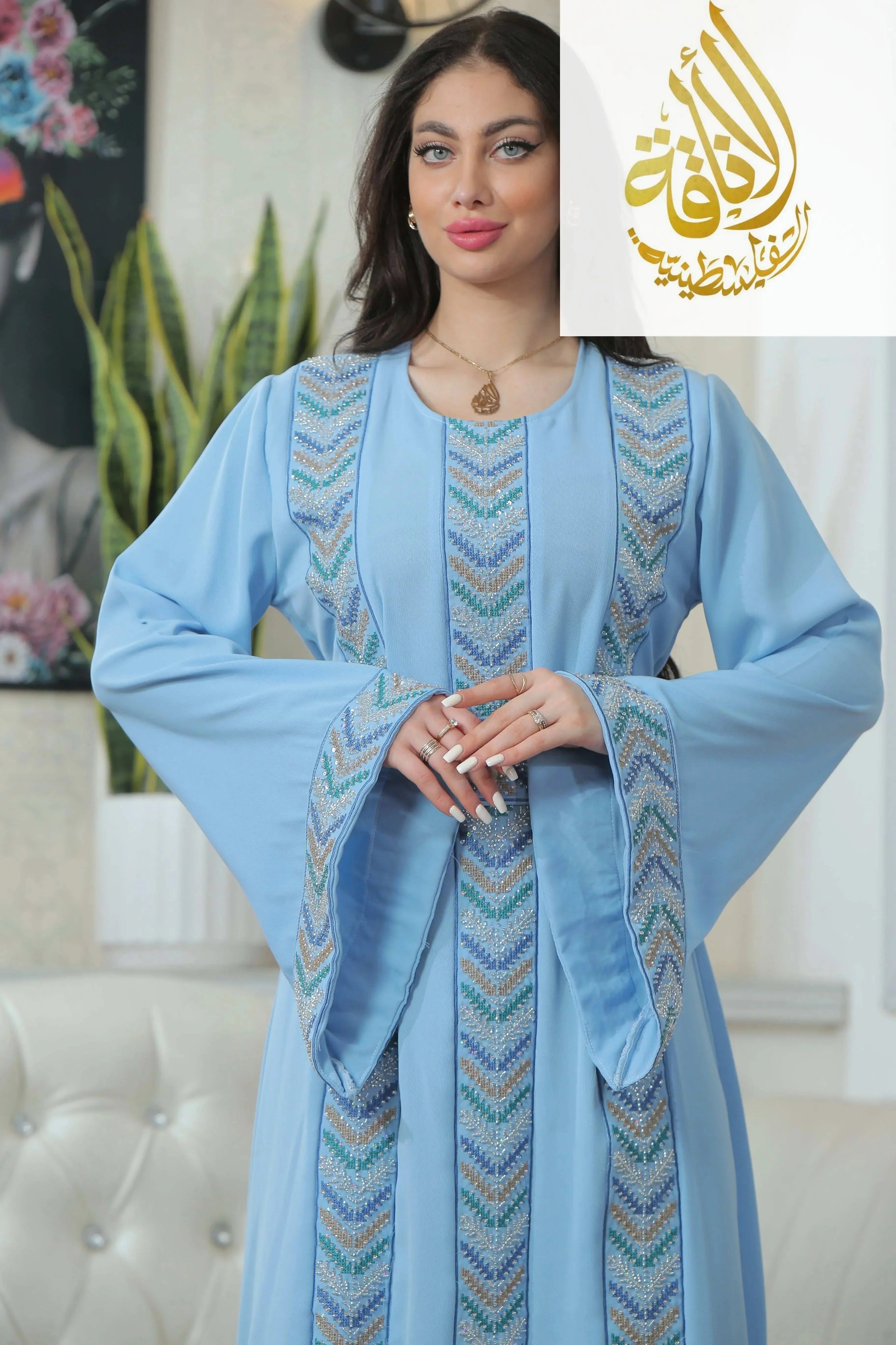 Palestinian Elegance Seham Embroidered Beads Thoub in light blue with detailed bead embroidery on sleeves and front