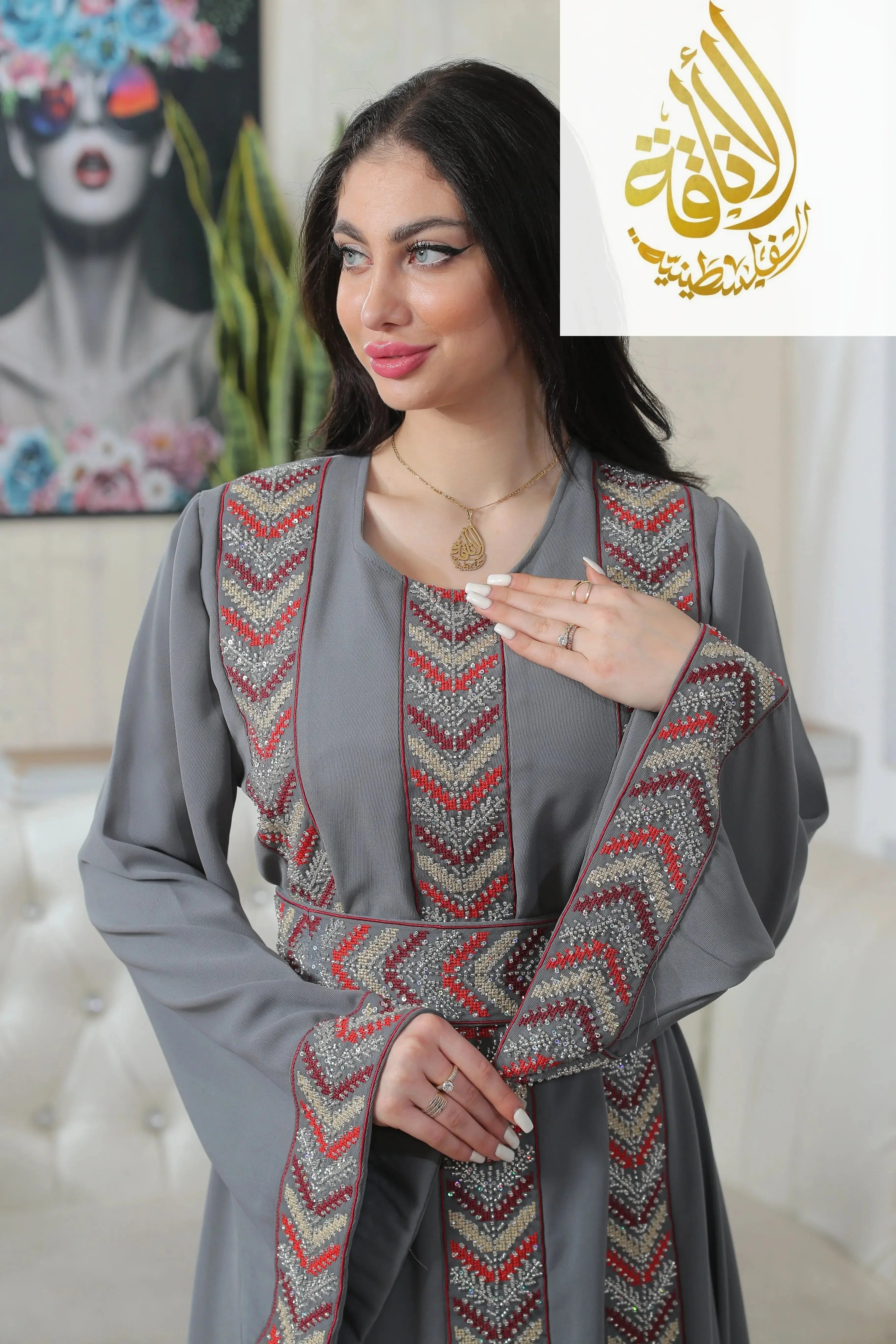 Woman wearing Palestinian Elegance Seham Embroidered Beads Thoub in gray with intricate red and silver beadwork details