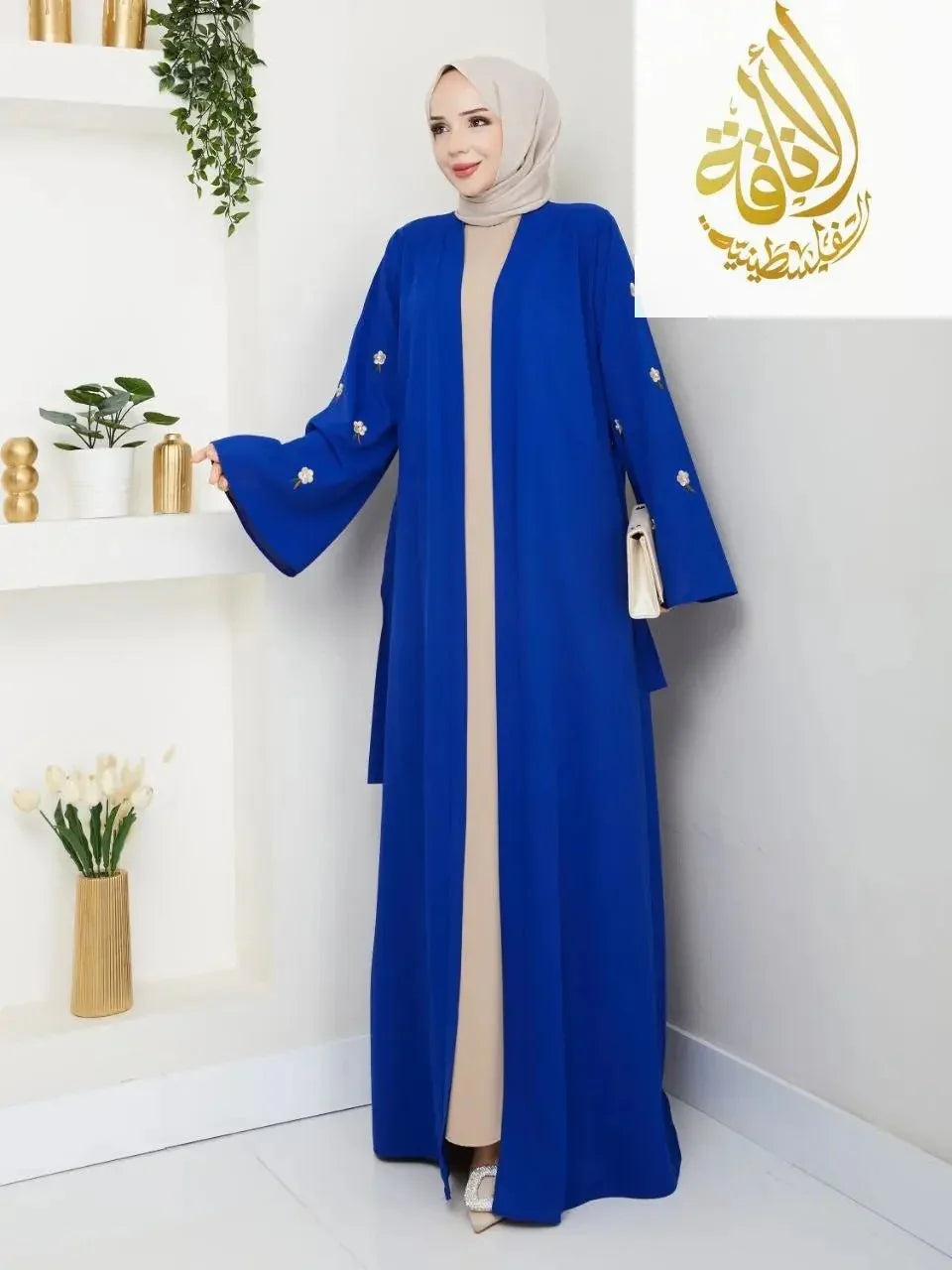 Palestinian Elegance modern abaya set featuring a blue outer layer with decorative sleeves over a beige inner dress