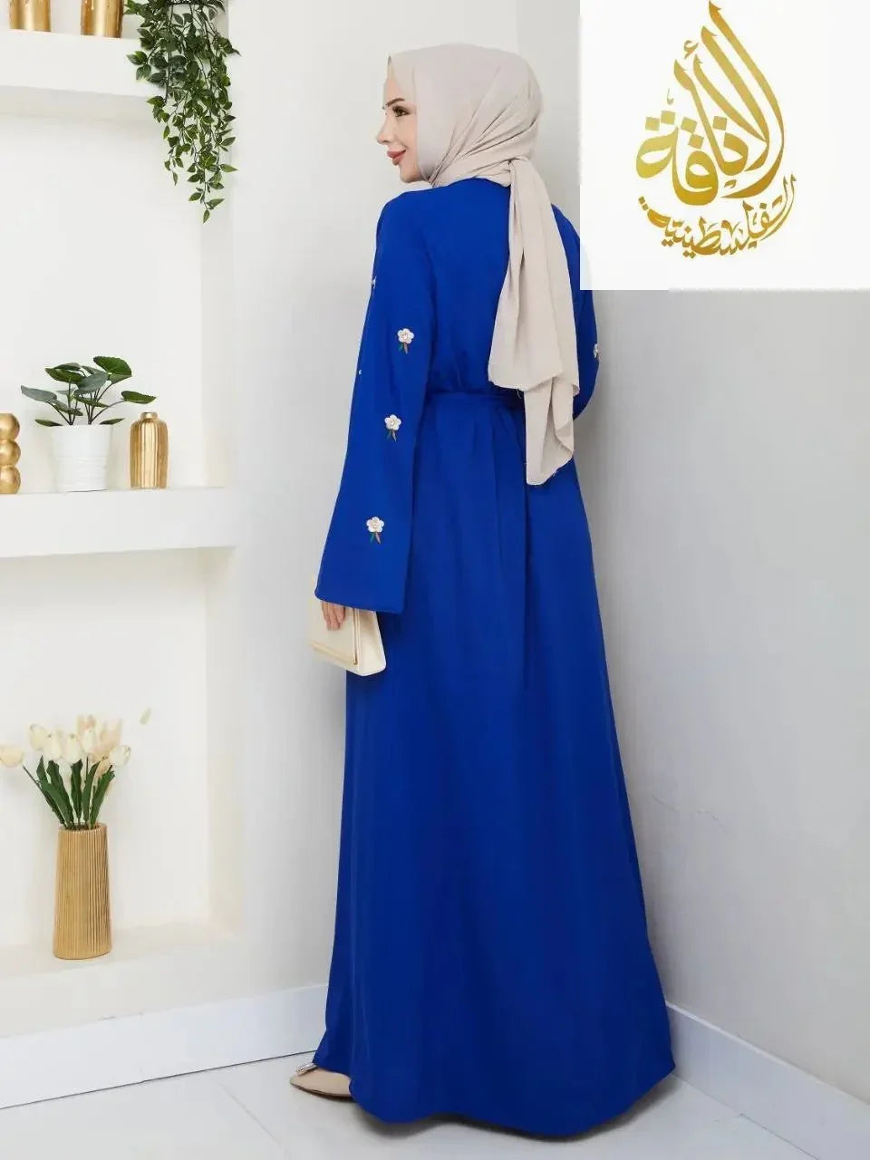 Palestinian Elegance blue modern abaya set with floral embroidery on sleeves worn by woman with beige hijab