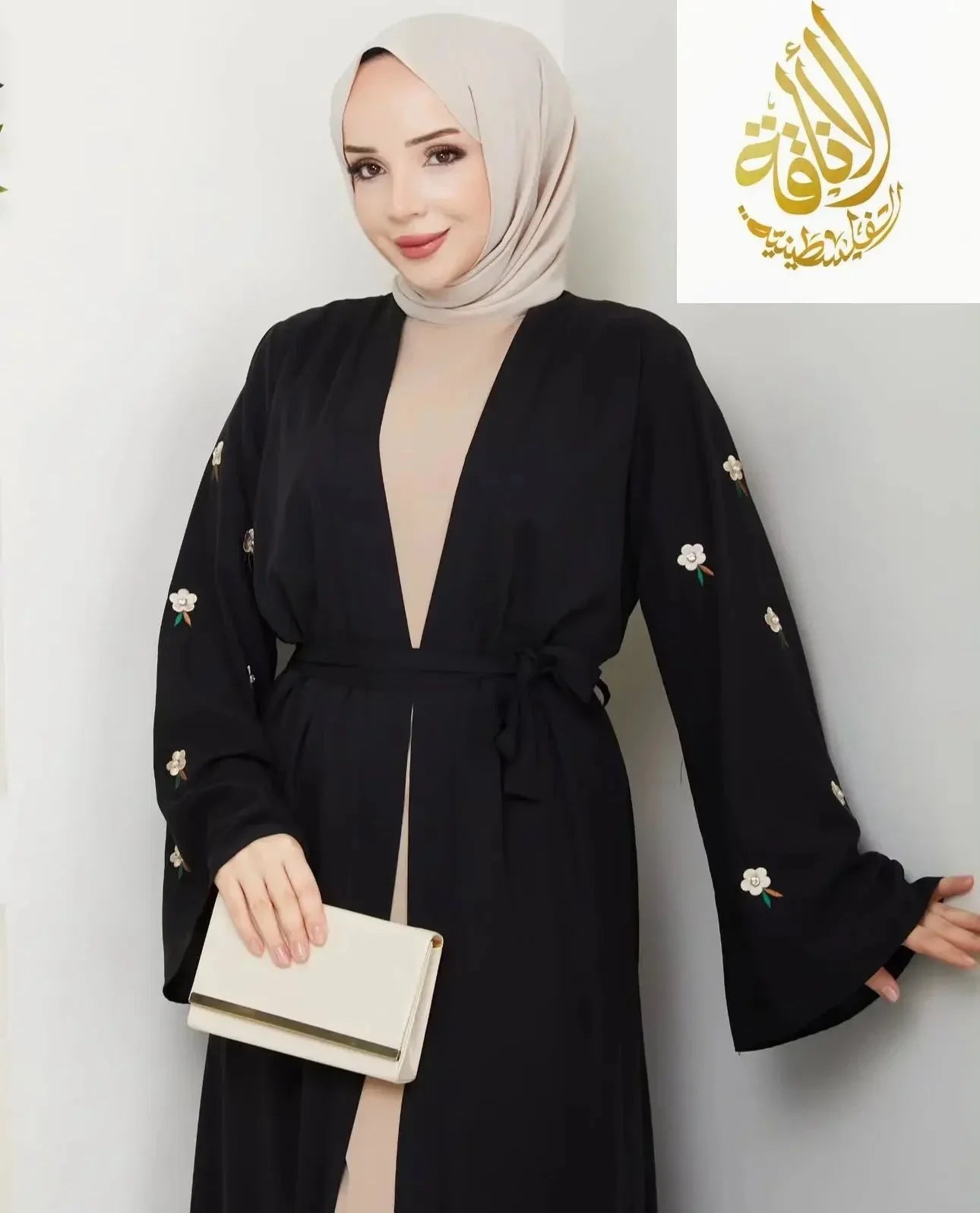 Palestinian Elegance modern abaya set featuring black fabric with floral embroidery and a matching belt