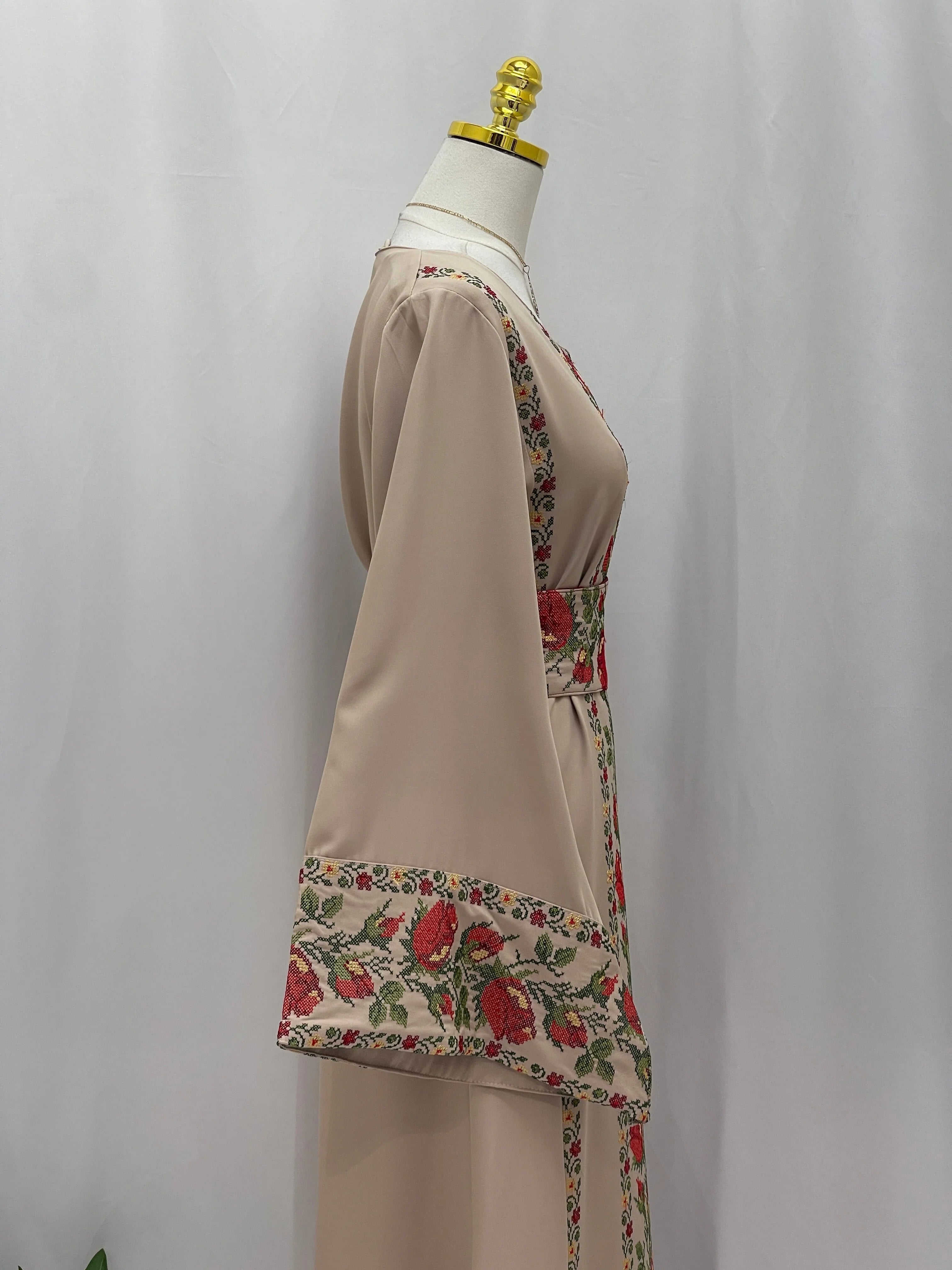 Side view of Shaqaeq Embroidered Thobe featuring intricate floral designs on sleeves and waist