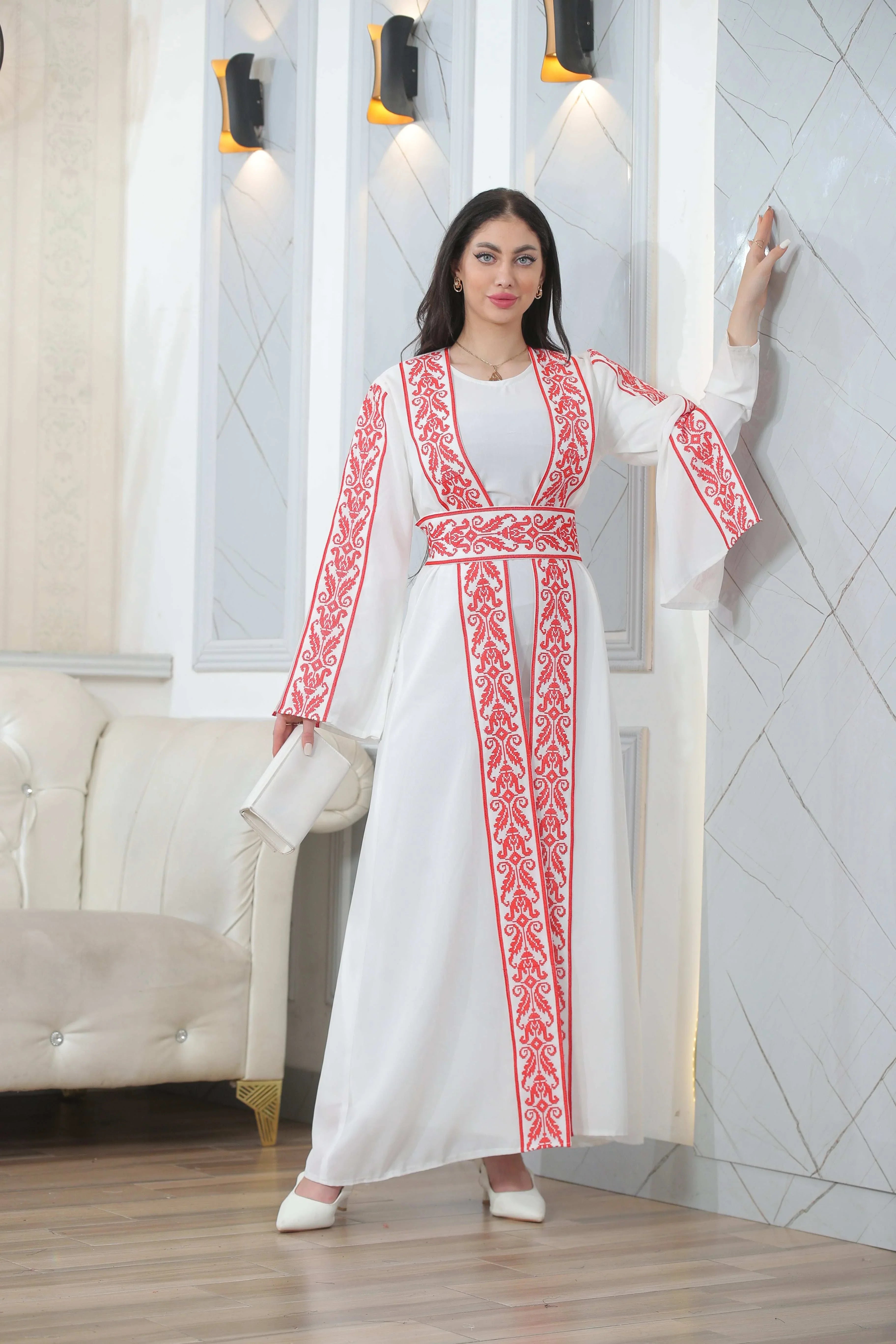 Woman wearing Shereen Embroidered Bisht Abaya white thoub with red embroidery by Palestinian Elegance