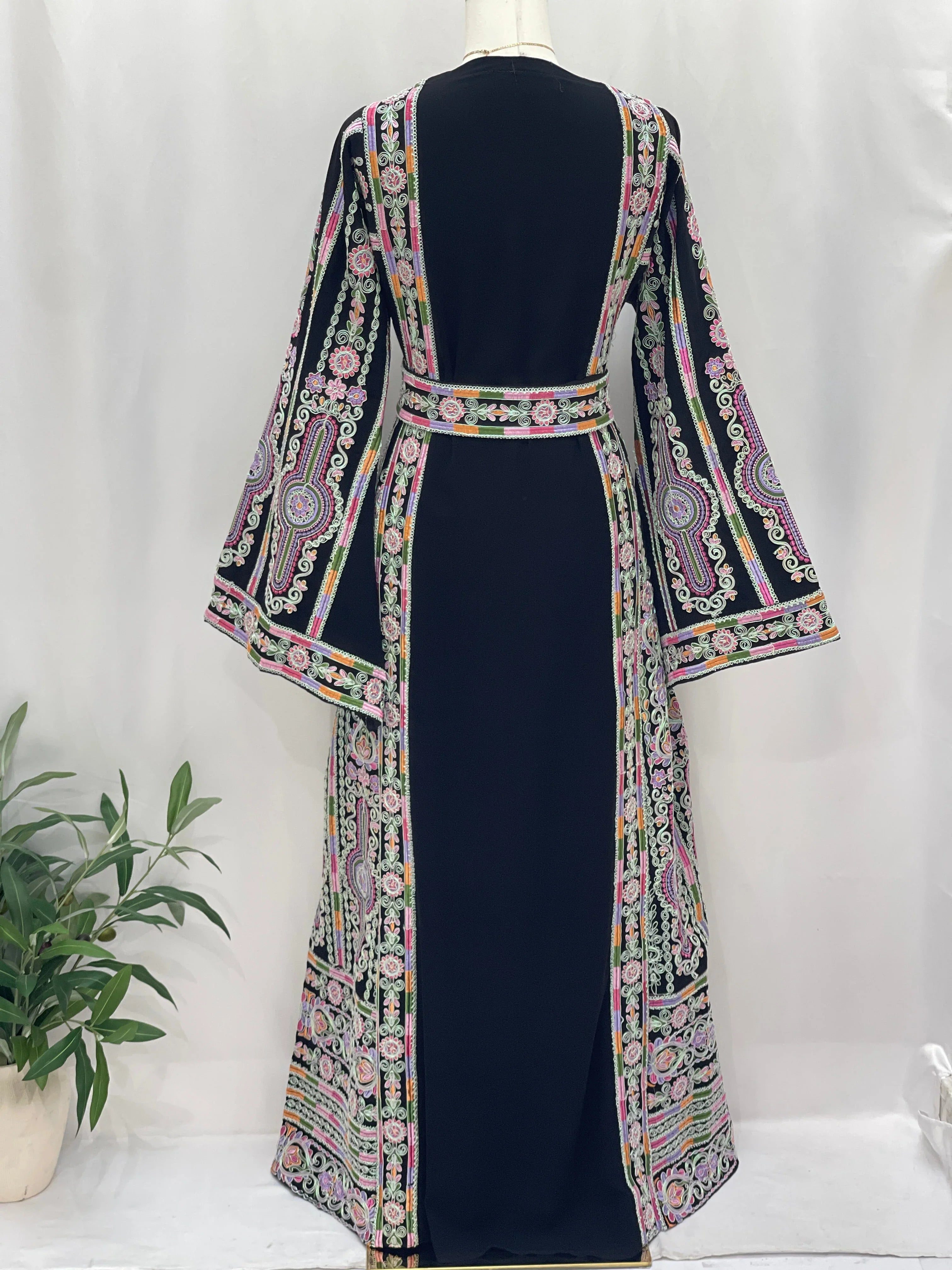 Silver Piping Embroidered Thobe by Palestinian Elegance back view navy thobe with colorful hand embroidery and belt