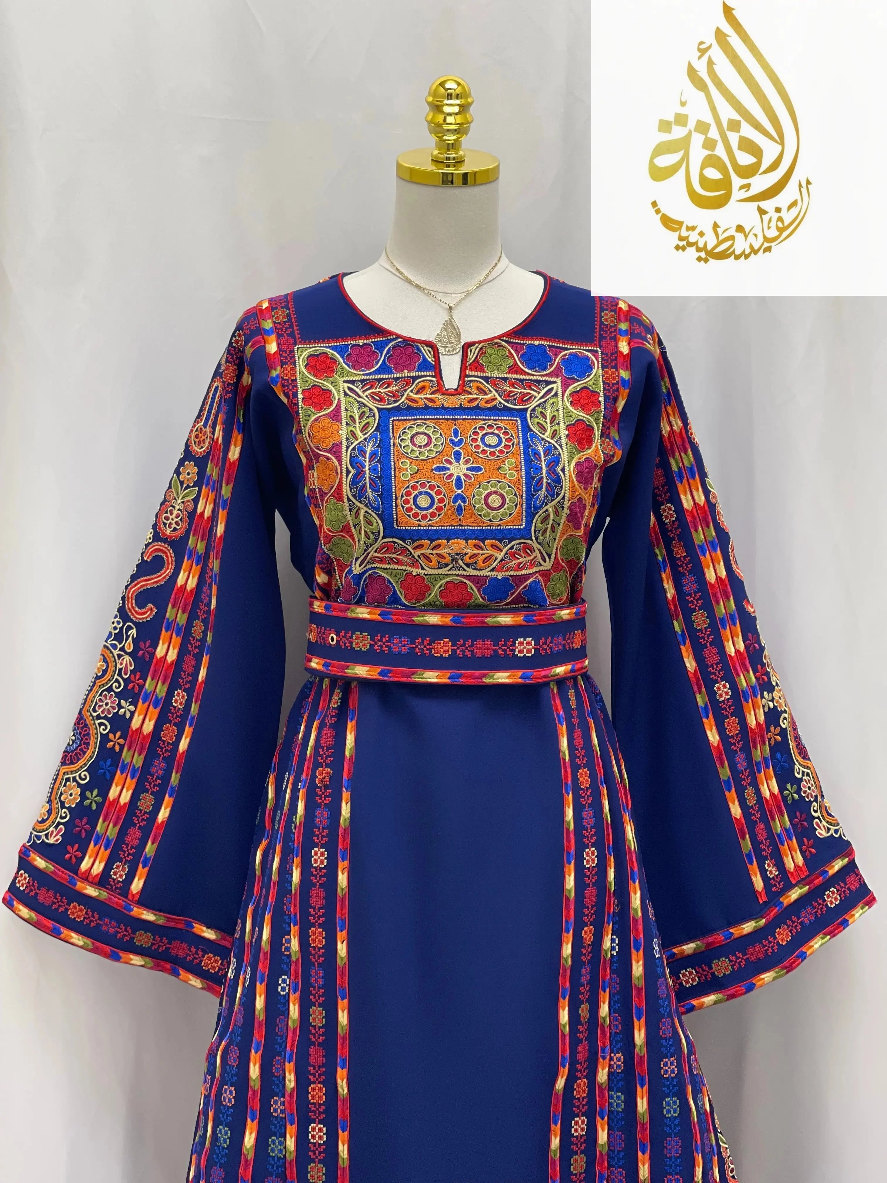 Embroidered Palestinian dress by Palestinian Elegance in blue with colorful traditional embroidery on bodice and sleeves