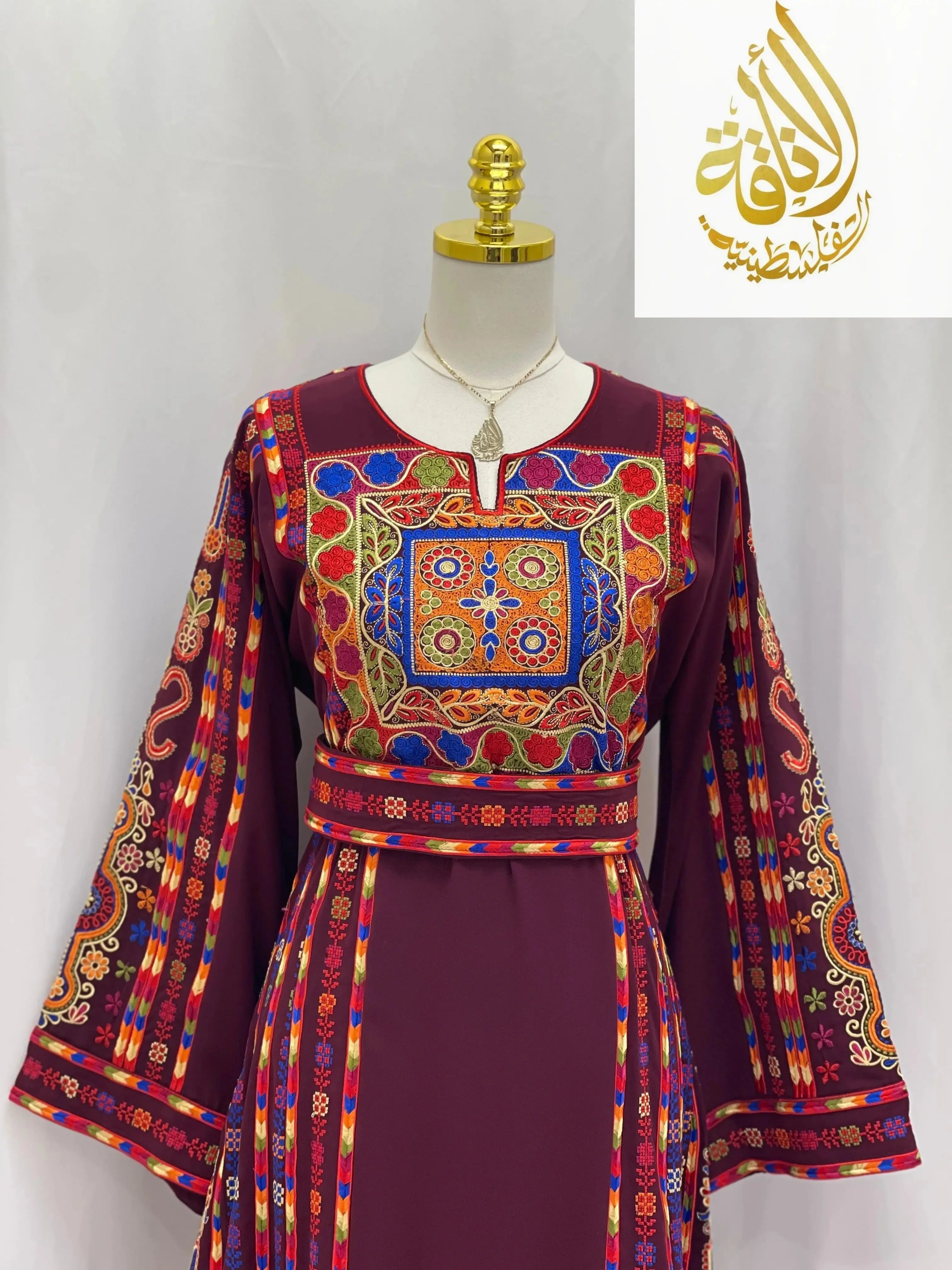 Embroidered Palestinian dress in deep purple with colorful traditional embroidery by Palestinian Elegance