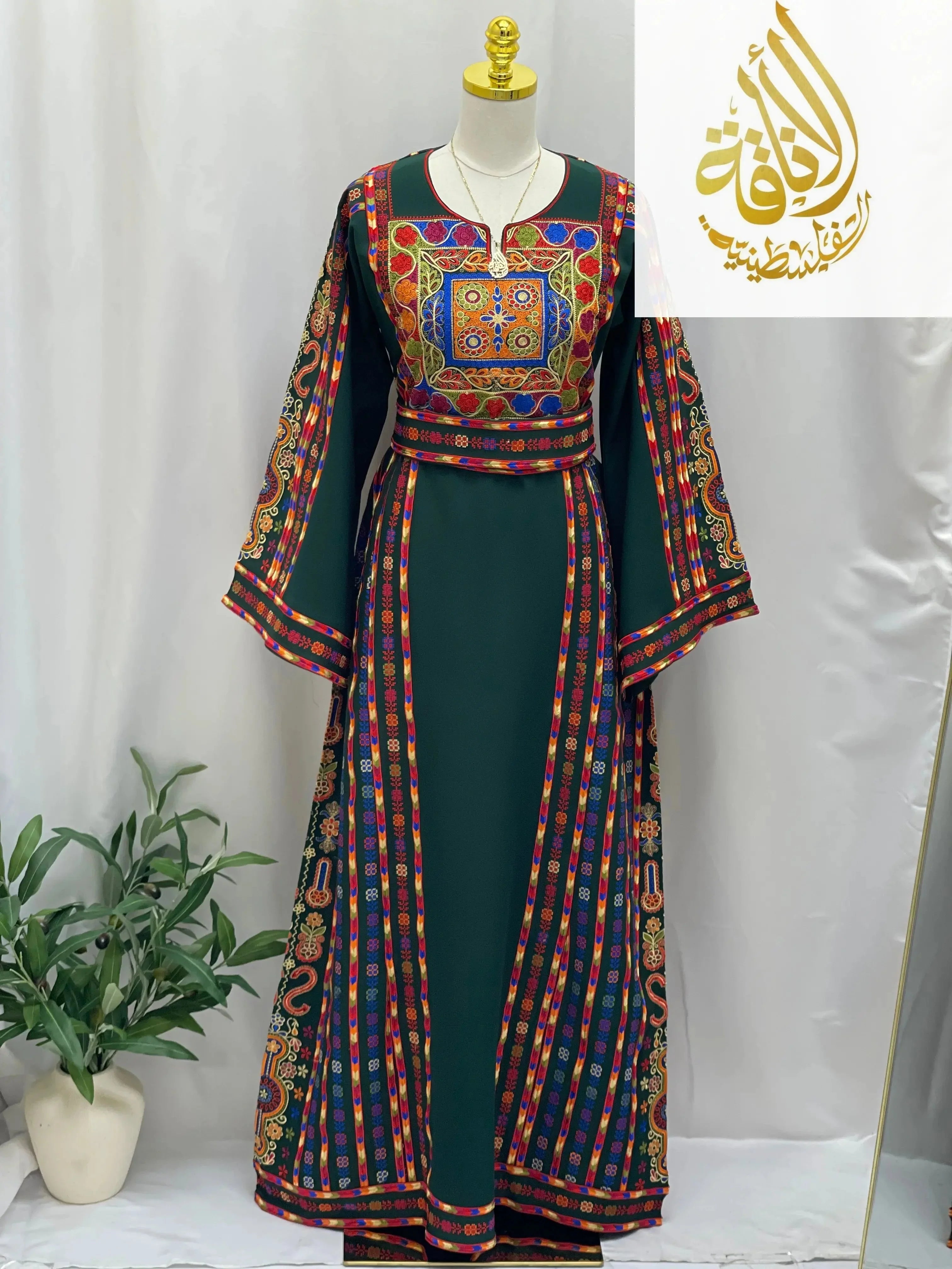 Dark green embroidered Palestinian dress with colorful intricate embroidery from Palestinian Elegance